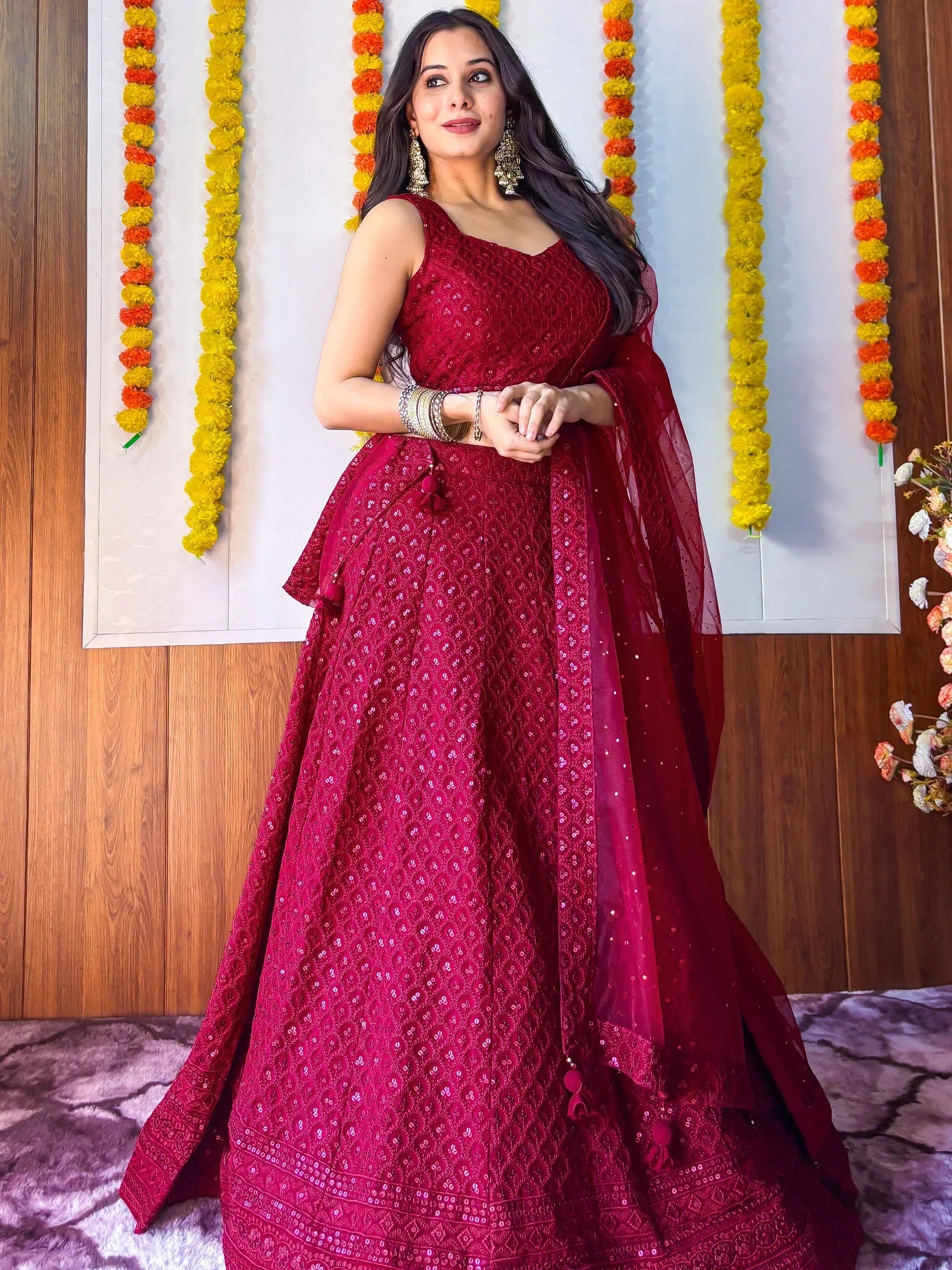 Elegant maroon lehenga choli with intricate embroidery, perfect for Indian weddings and festive occasions.