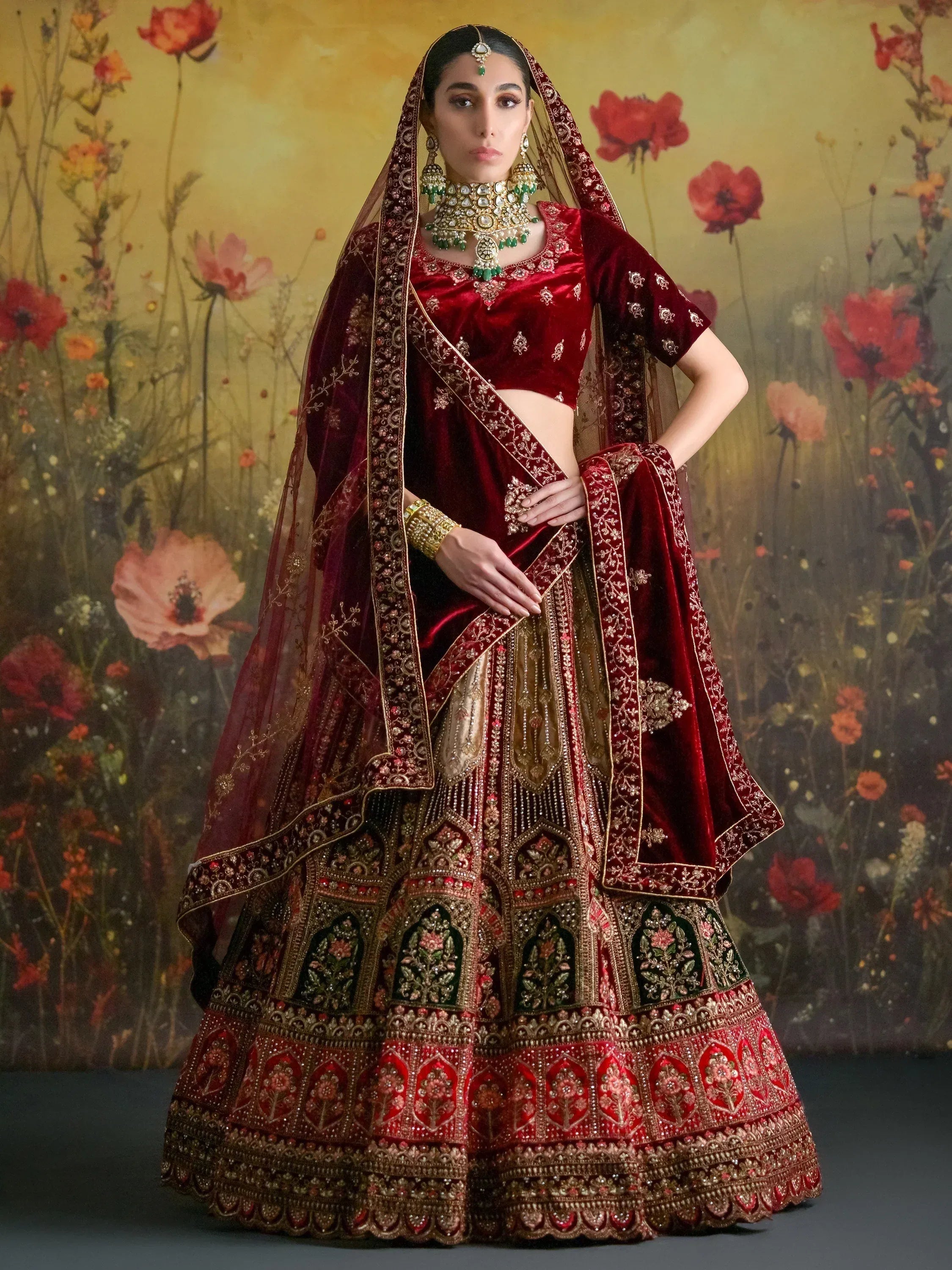Luxury red velvet lehenga choli with gold embroidery, perfect for Indian weddings and festive occasions.