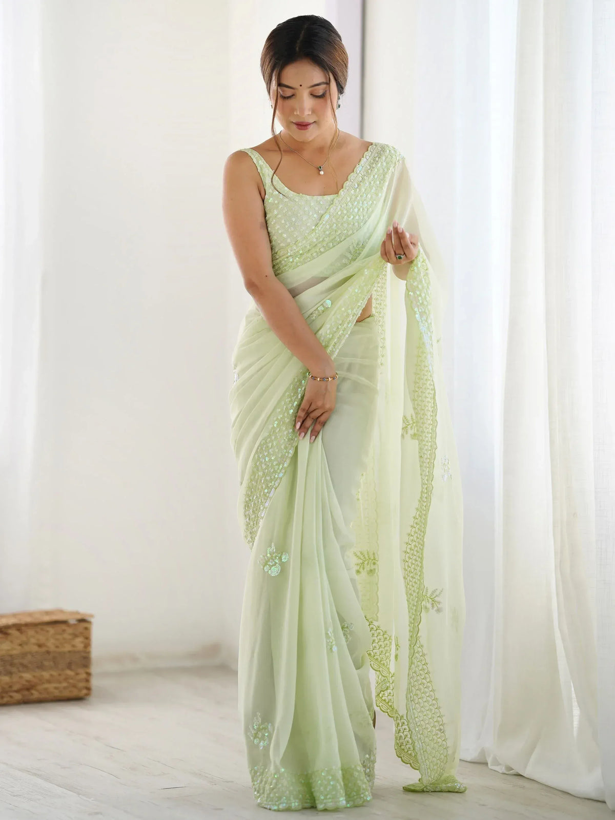Light green sequin saree with embroidered border, perfect for Indian ethnic wear occasions