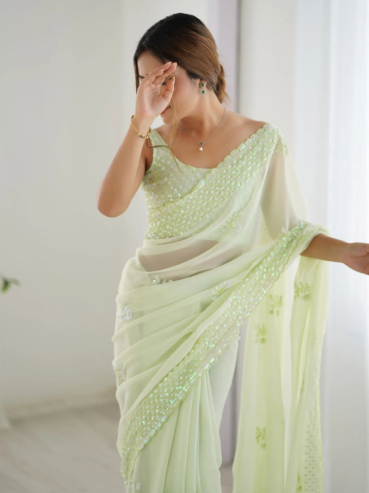 Mint green sequin saree with off-shoulder blouse, perfect for Indian ethnic wear events