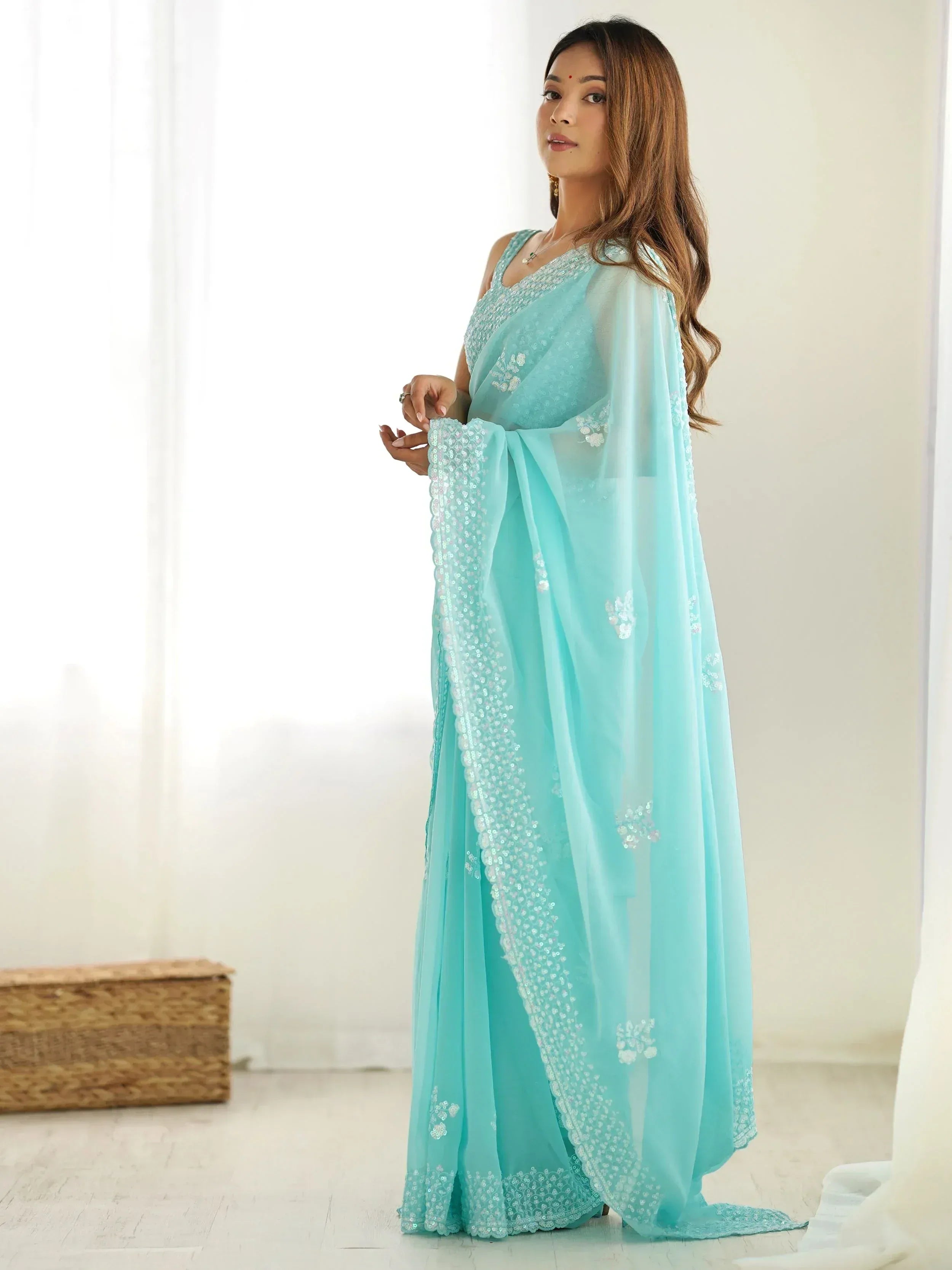 Light blue ethnic saree with sequin embroidery, perfect for Indian weddings or festive occasions.