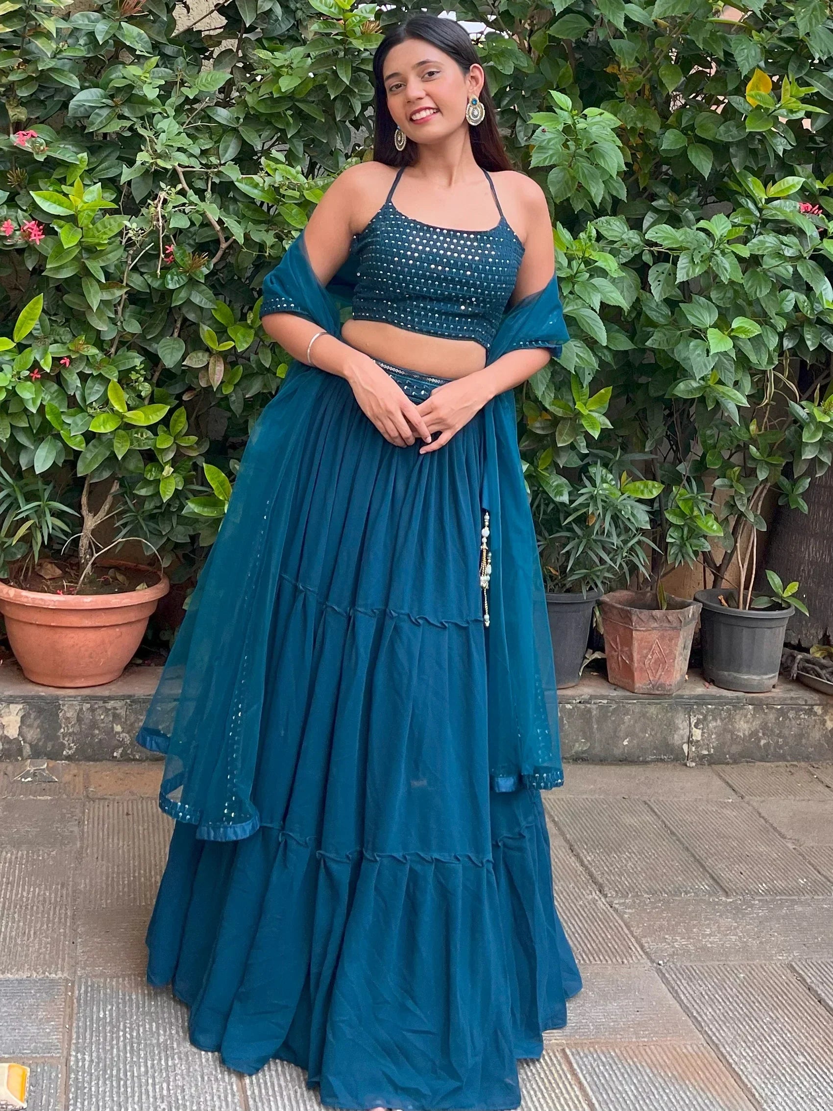 Teal designer lehenga choli with sequin top and layered skirt, perfect for Indian ethnic wear occasions