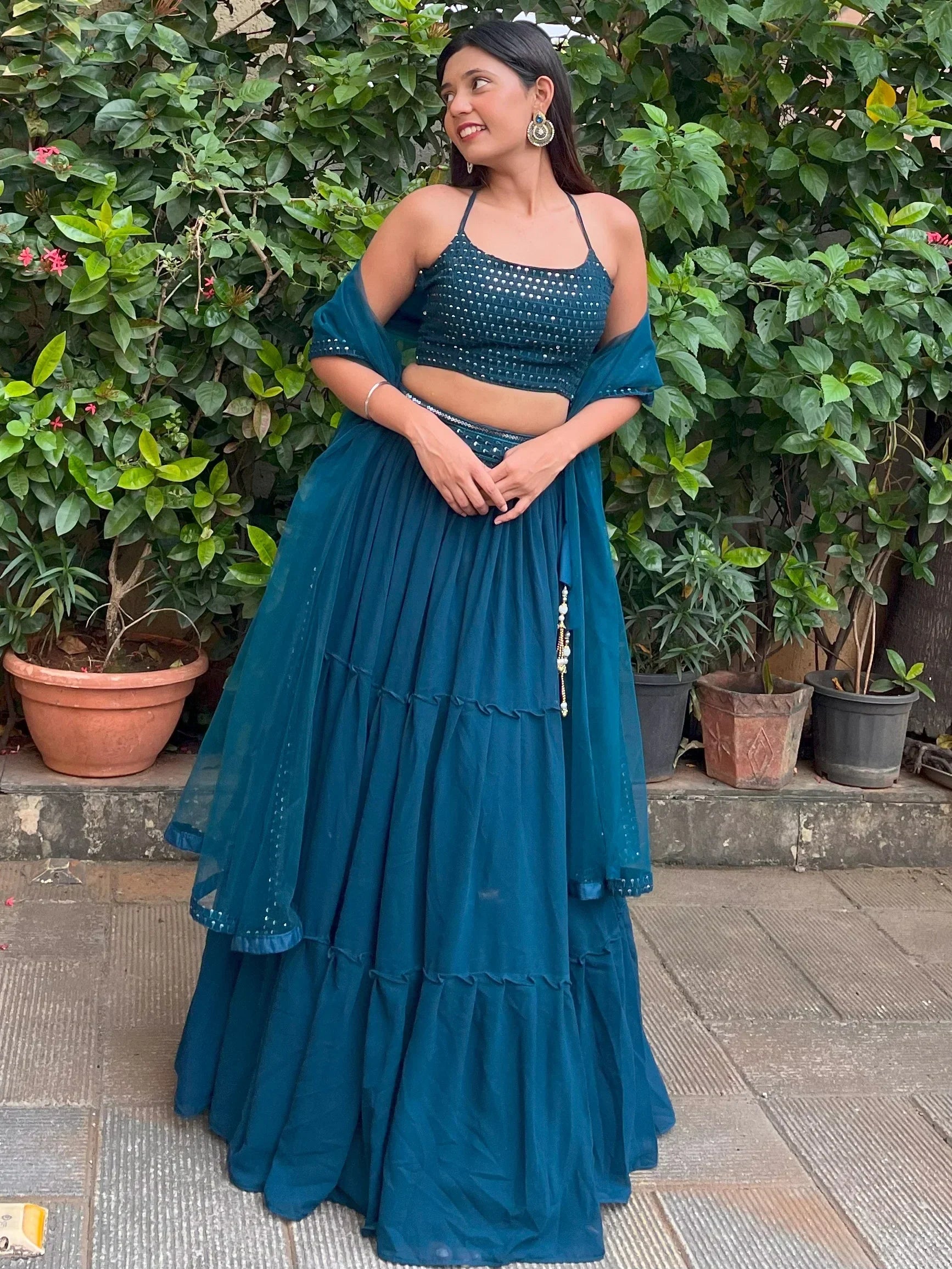 Teal blue designer lehenga choli with sequin top and tiered skirt, perfect for Indian ethnic wear occasions