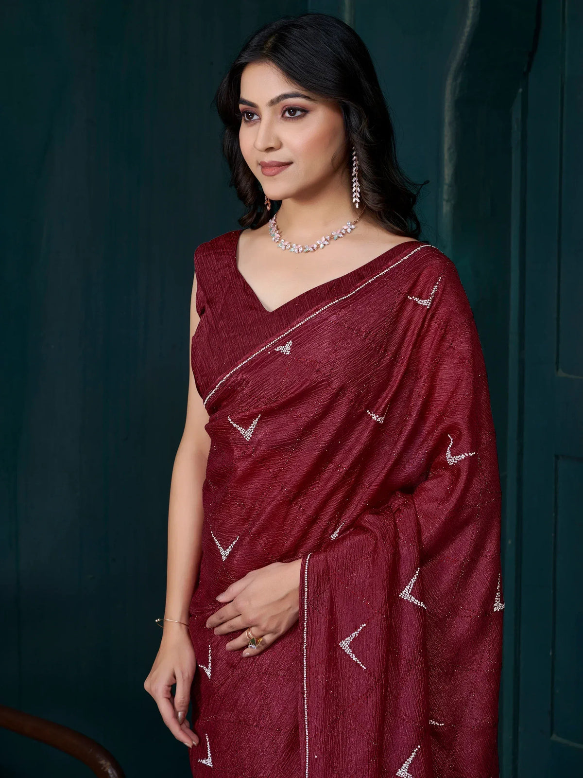 Maroon designer saree with crystal embellishments, perfect for ethnic occasions and festive wear.