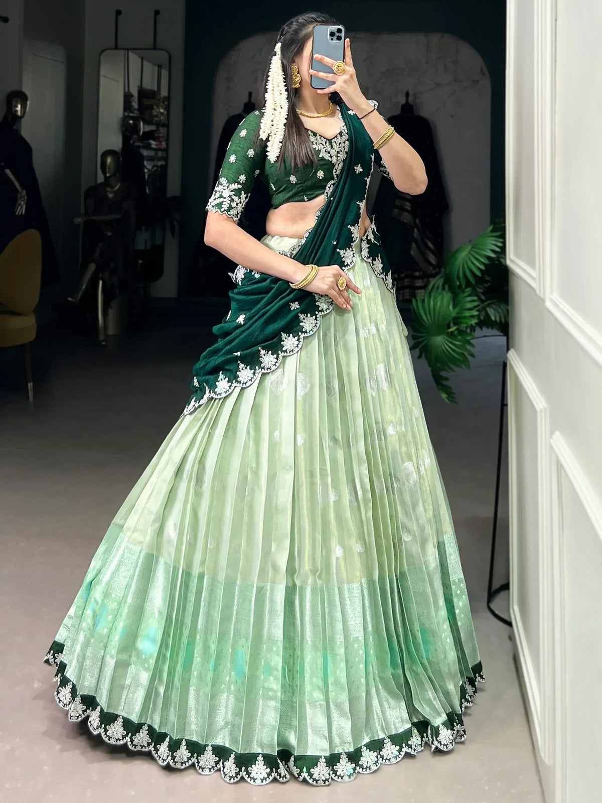 Emerald green embroidered lehenga choli with floral detailing, perfect for Indian ethnic wear occasions.