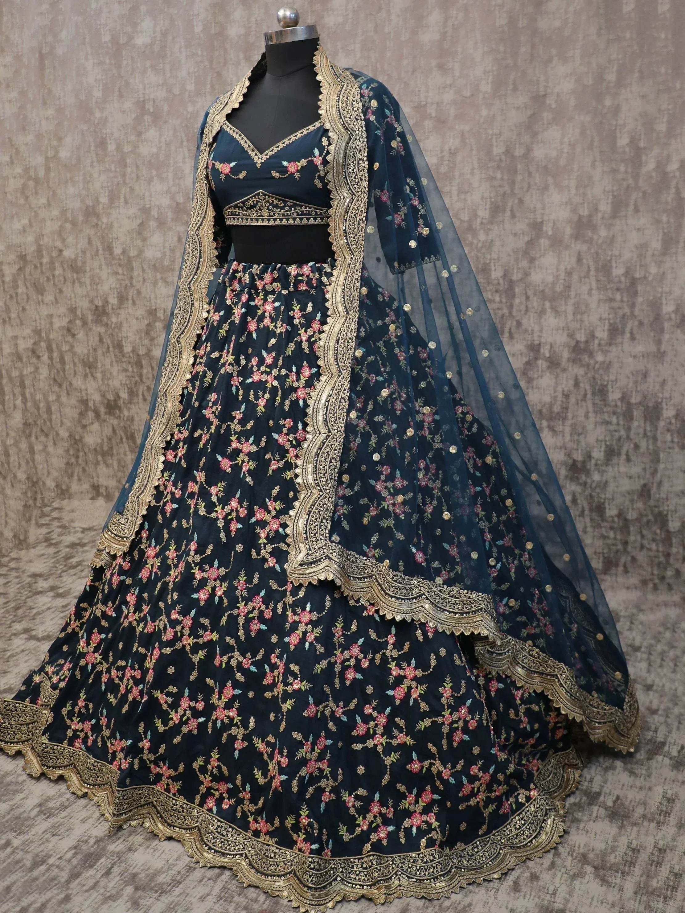 Dark blue embroidered lehenga choli with gold detailing and floral motifs, perfect for Indian ethnic wear.
