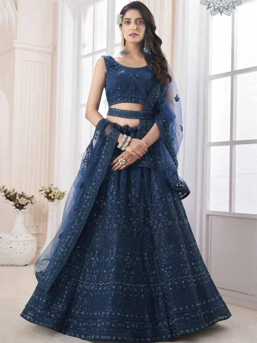 Navy blue designer lehenga choli with intricate embroidery and sheer dupatta, perfect for Indian ethnic occasions