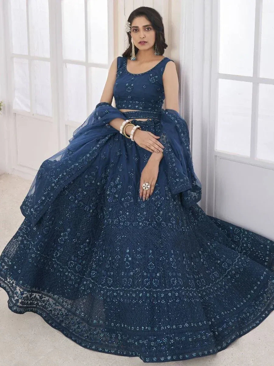 Navy blue designer lehenga choli with intricate embroidery and sequins, perfect for Indian ethnic wear occasions.
