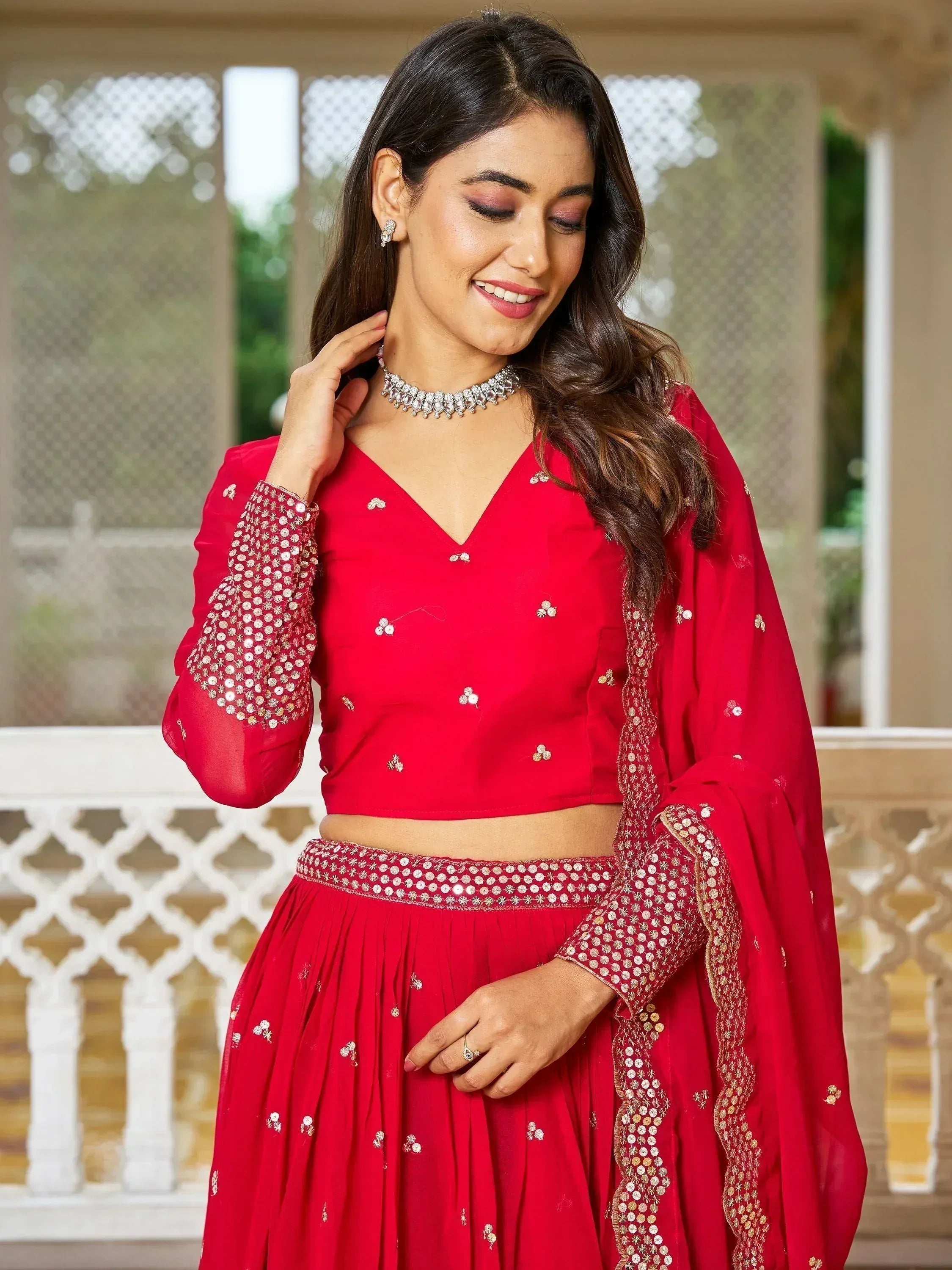 Red designer lehenga choli with sequin embroidery, perfect for Indian ethnic wear and festive occasions.