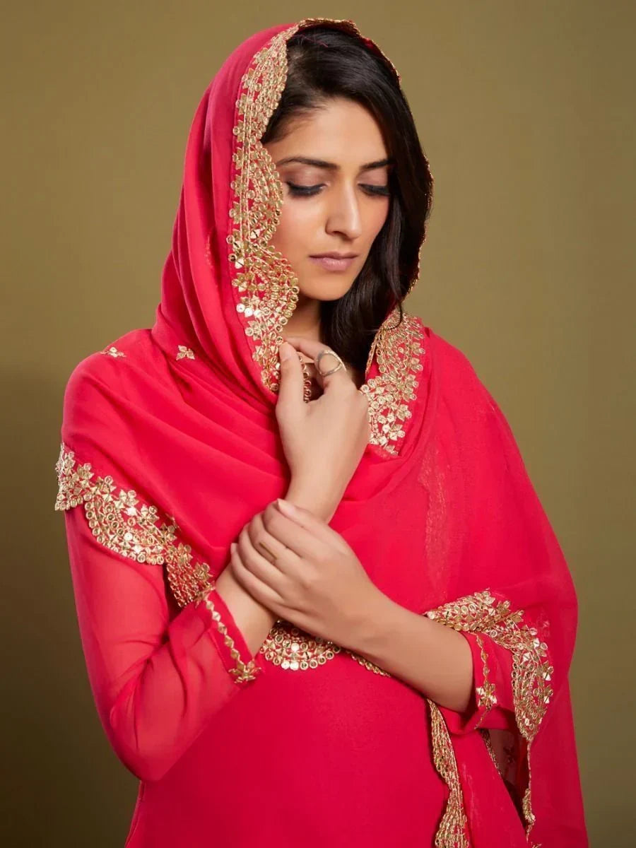 Woman in pink embroidered dupatta and ethnic gown with gold detailing