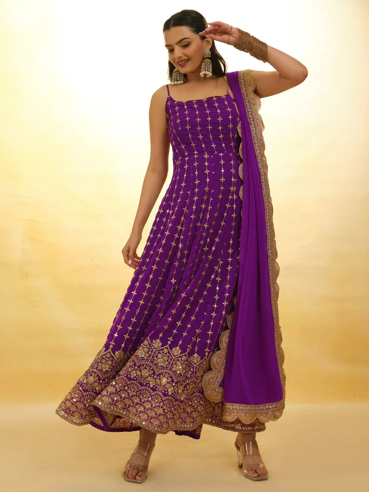Purple ethnic gown with gold embroidery and matching dupatta, perfect for Indian occasions