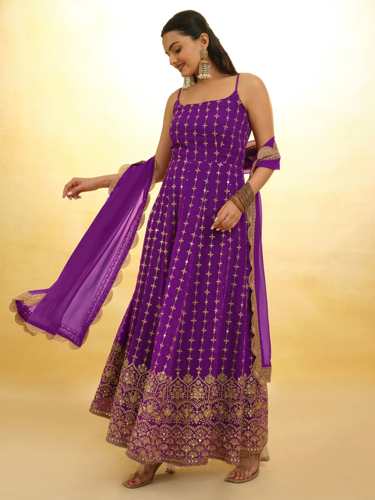 Purple ethnic anarkali gown with gold embroidery and dupatta, perfect for Indian weddings or festive occasions