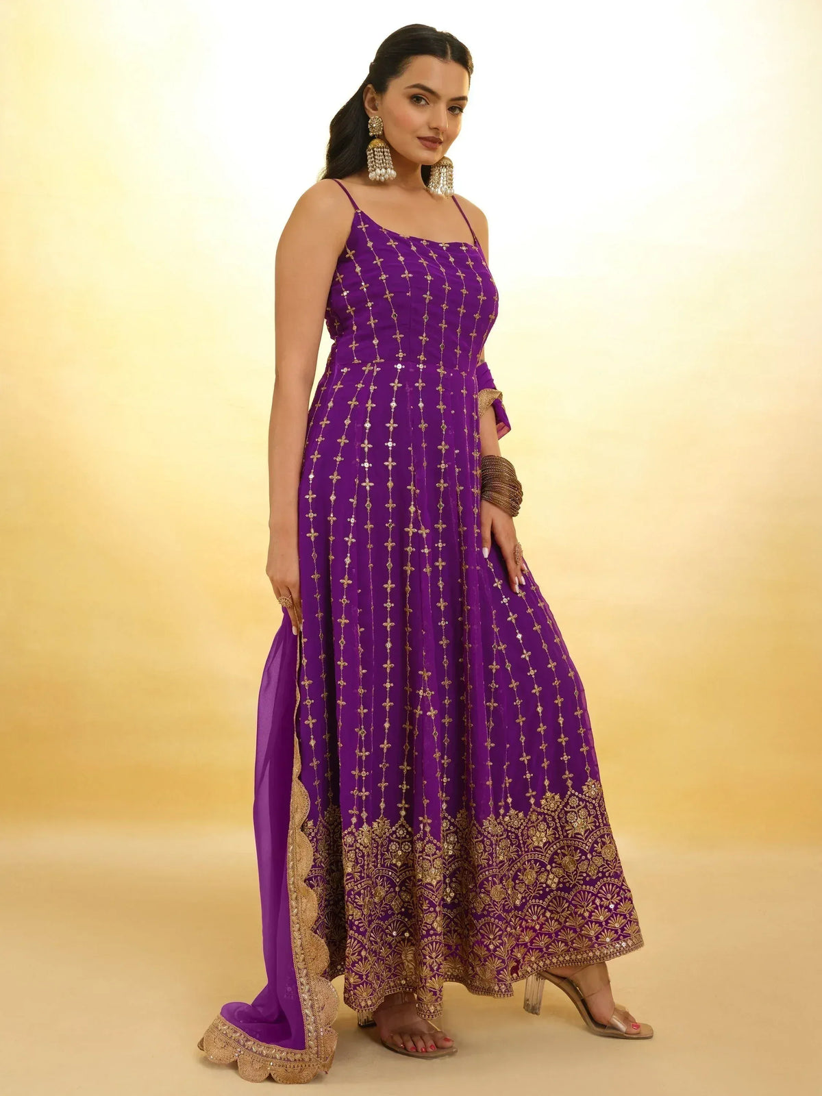 Purple ethnic gown with gold embroidery, perfect for Indian weddings and festive occasions
