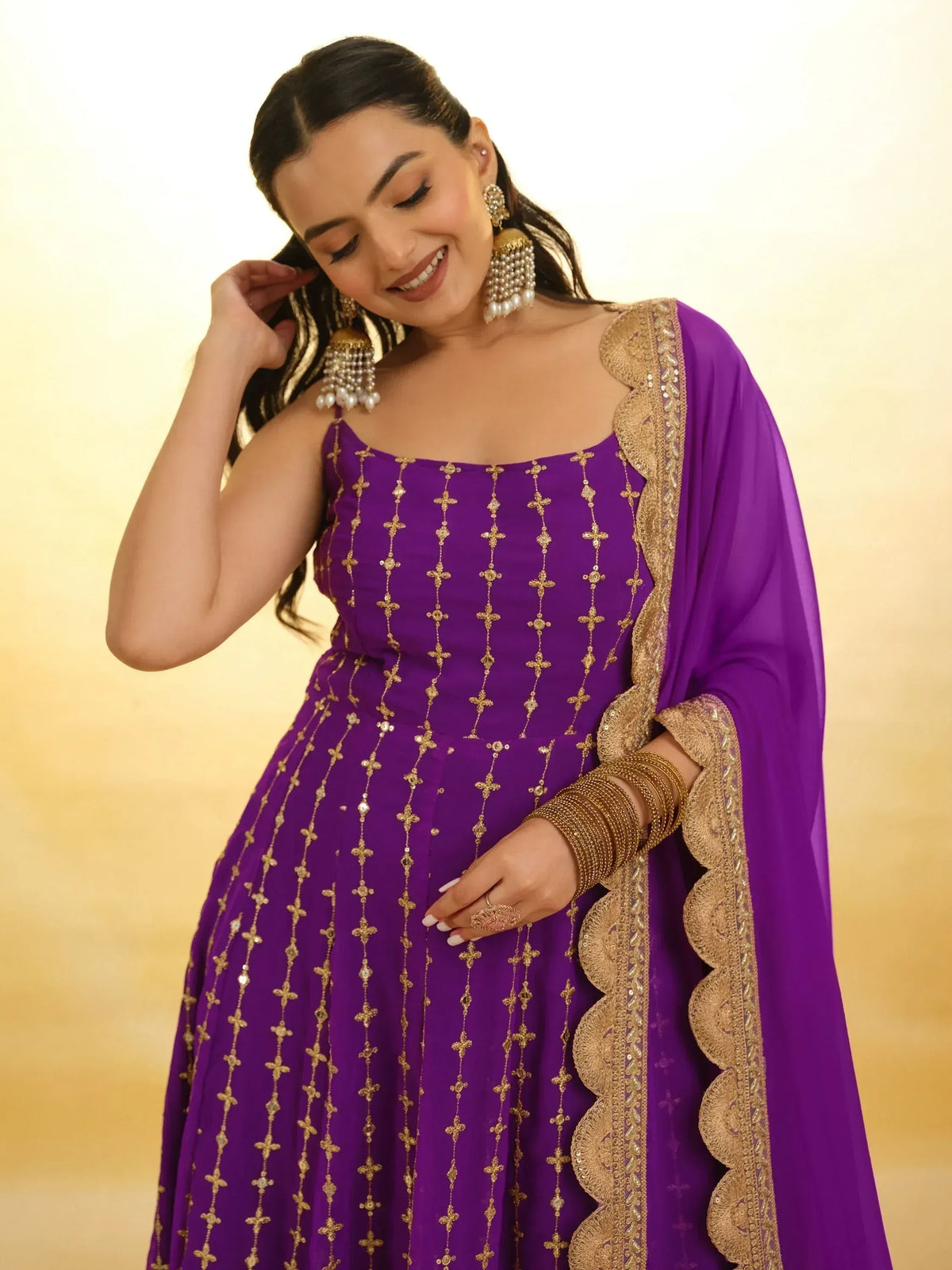 Purple ethnic gown with gold embroidery, perfect for Indian weddings and festive occasions