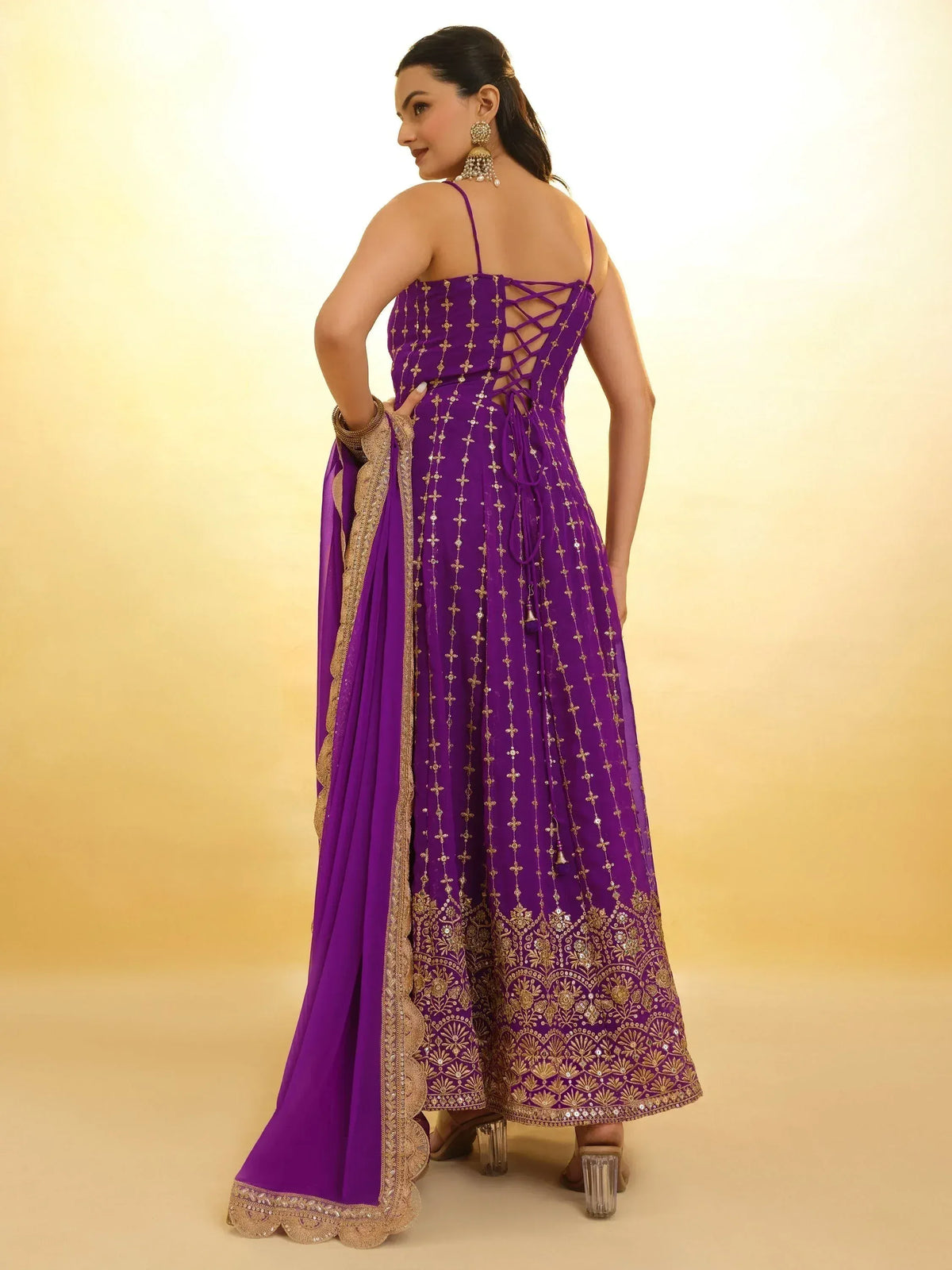 Purple ethnic gown with gold embroidery and lace-up back, perfect for Indian celebrations