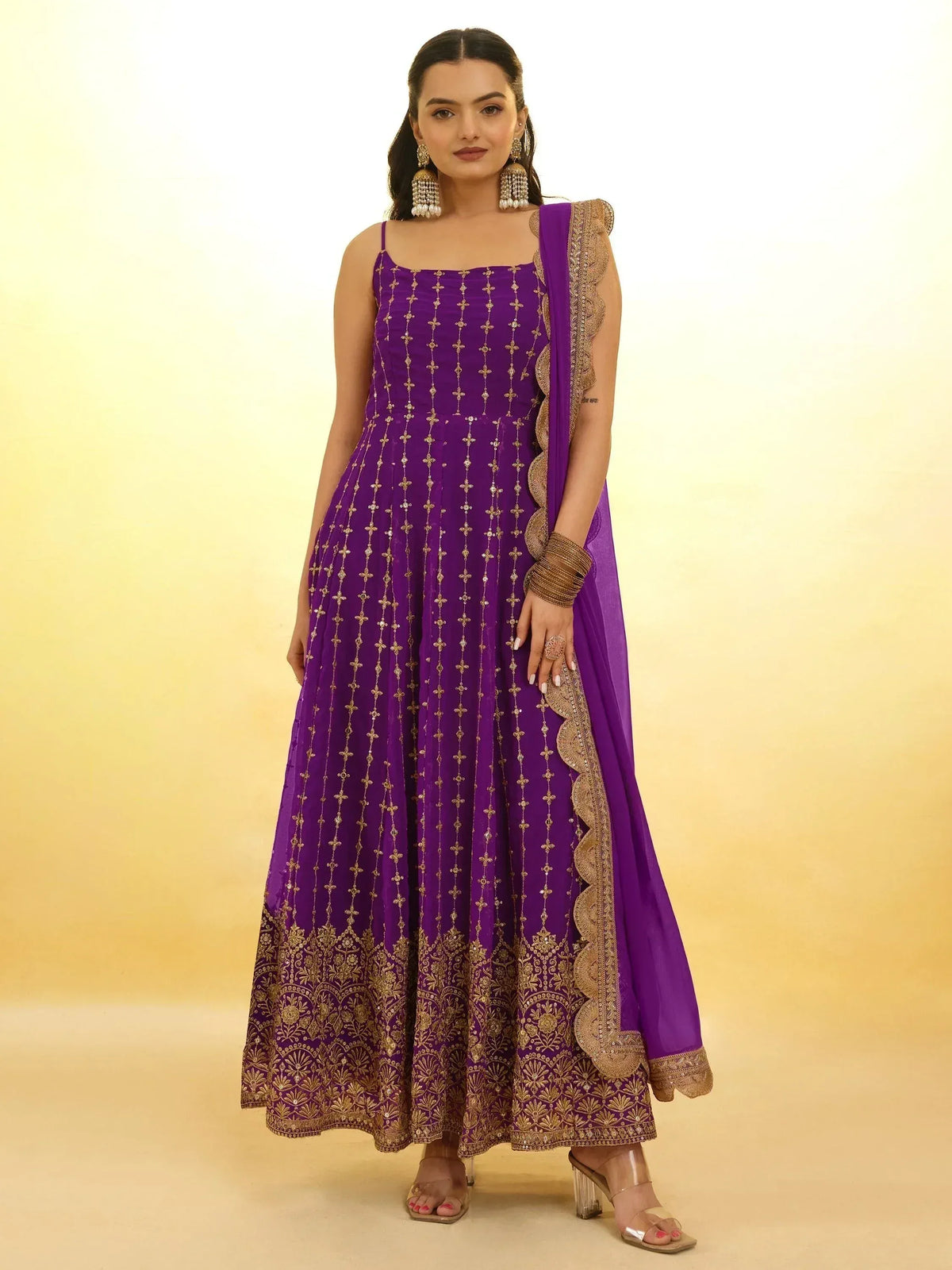 Purple ethnic anarkali gown with gold embroidery and dupatta, perfect for Indian weddings and festive occasions