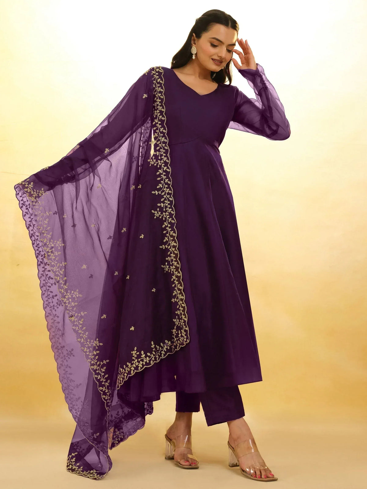 Purple ethnic anarkali suit with gold embroidery and sheer dupatta, perfect for Indian occasions