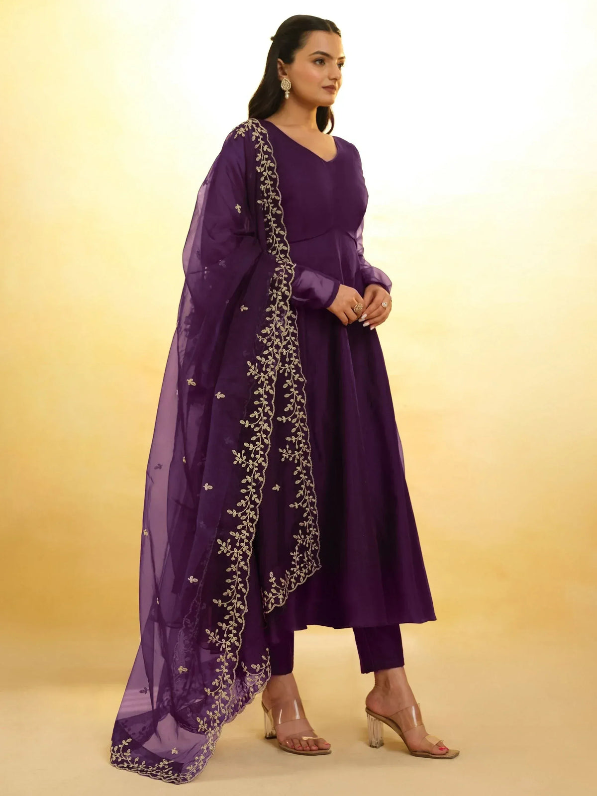 Purple ethnic anarkali suit with gold embroidery and sheer dupatta, perfect for Indian occasions