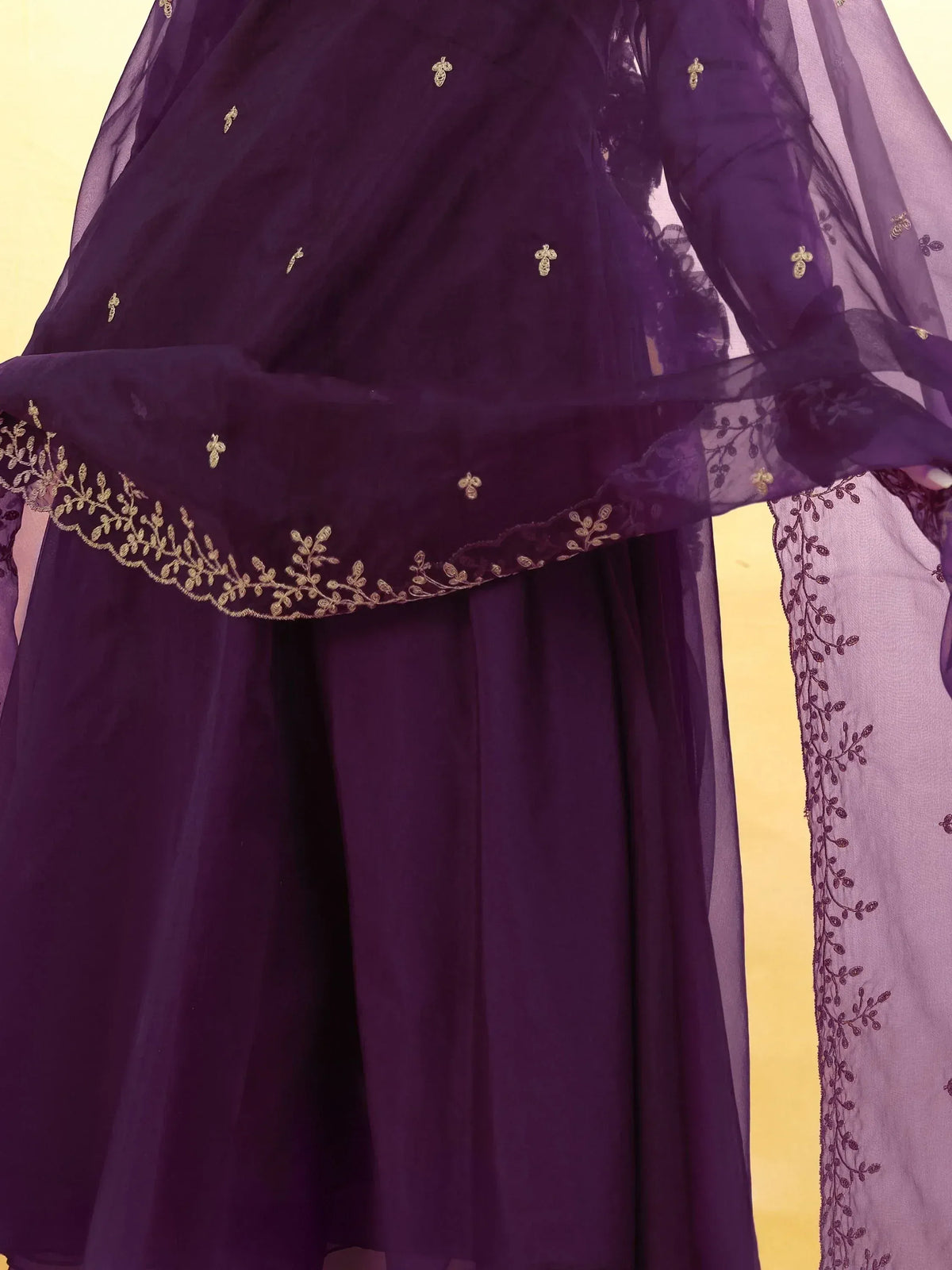 Purple ethnic gown with gold embroidery and sheer overlay, perfect for Indian occasions