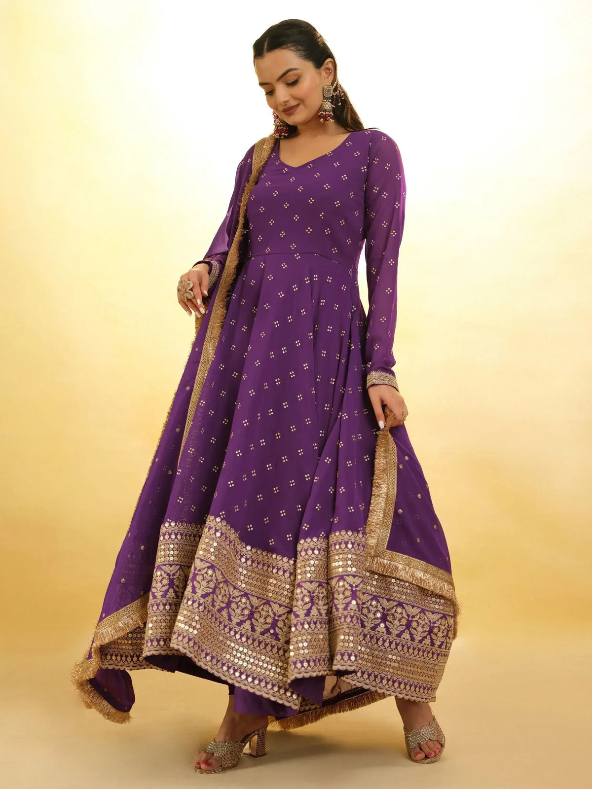 Purple ethnic anarkali gown with gold embroidery and sequins, perfect for Indian occasions