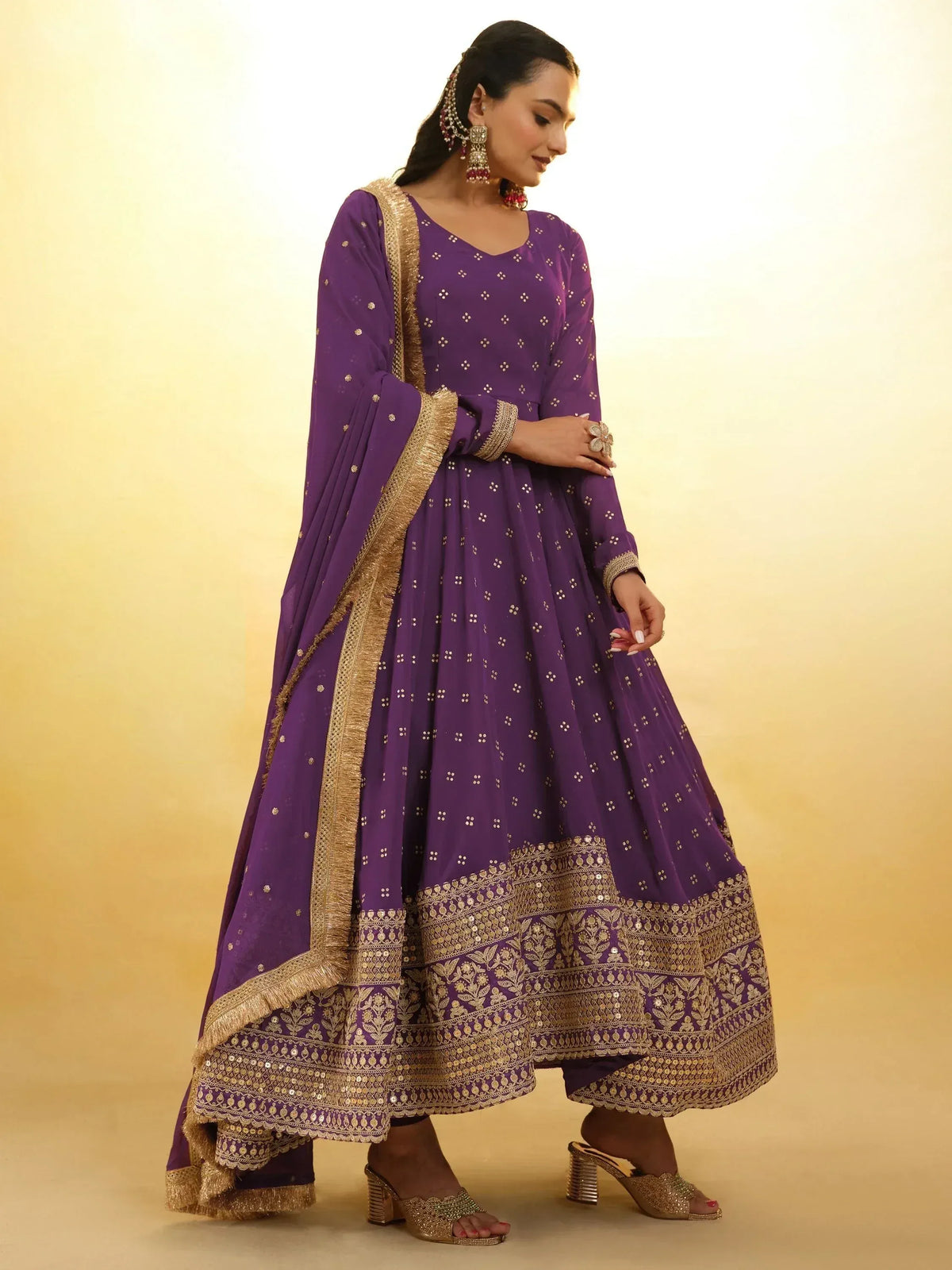 Purple ethnic anarkali suit with gold embroidery and dupatta, perfect for Indian weddings and parties.