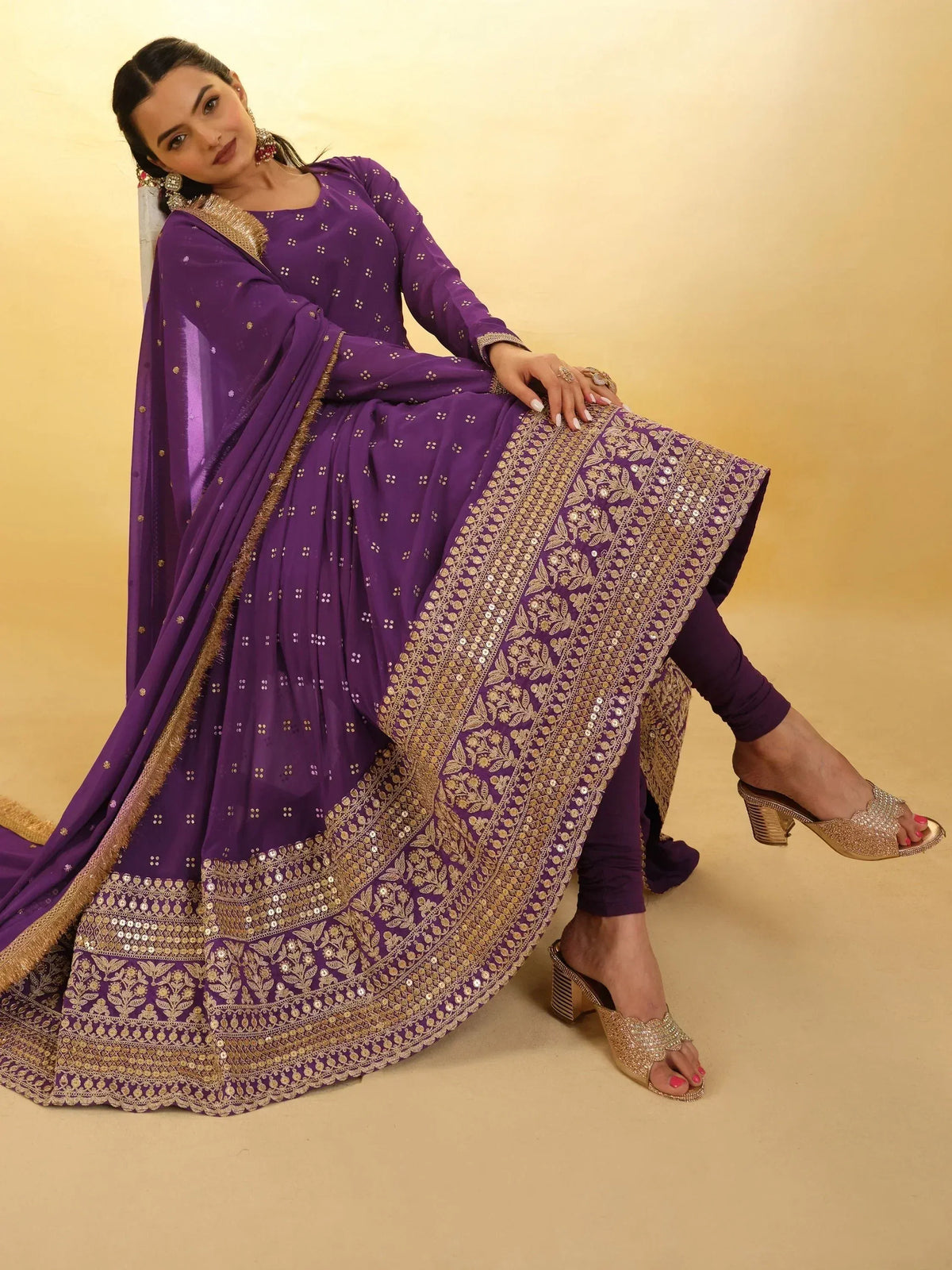 Purple Indian ethnic anarkali suit with gold embroidery and sequins, perfect for festive occasions