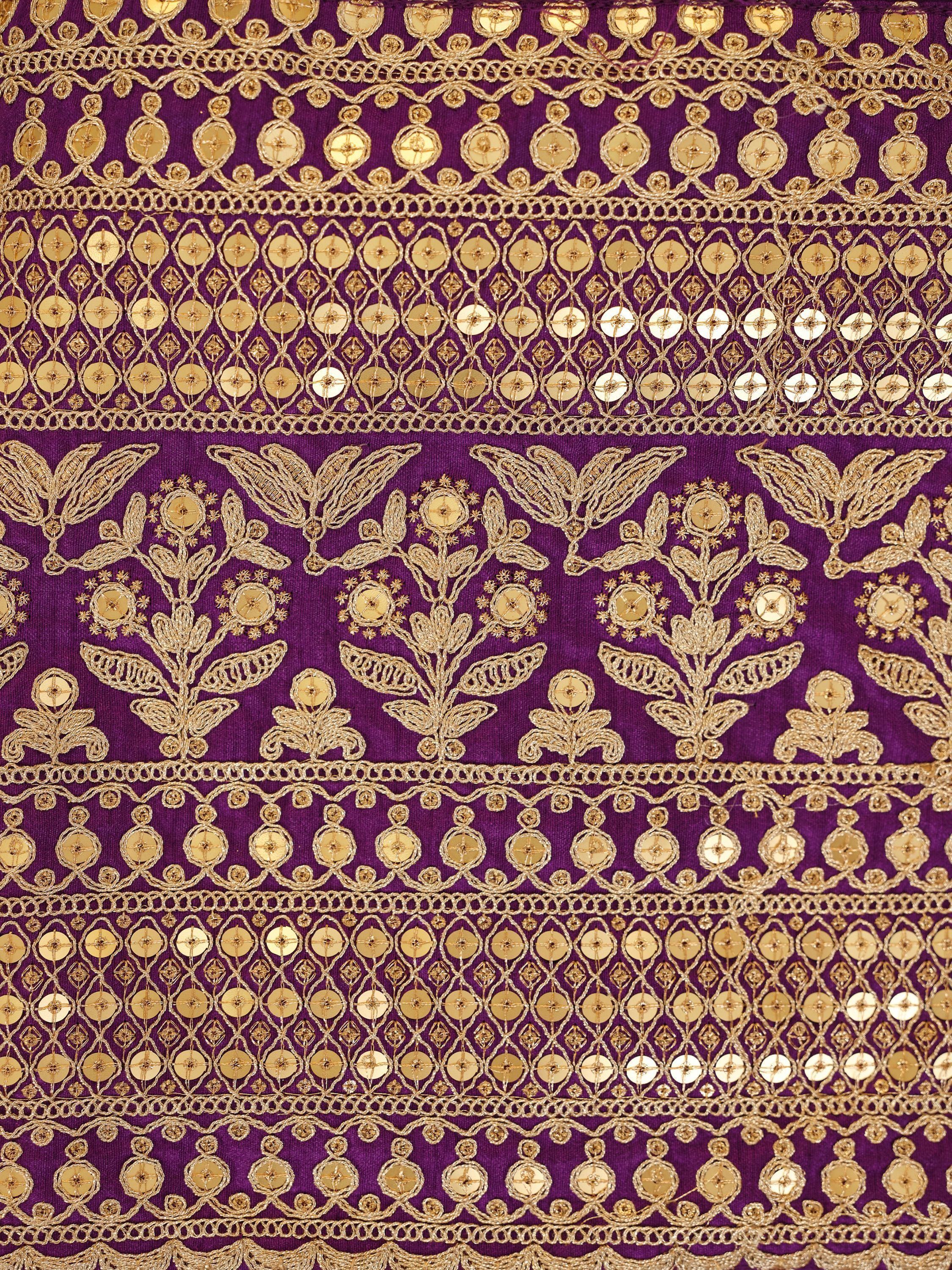 Purple ethnic fabric with intricate gold embroidery and mirror work, floral and geometric designs