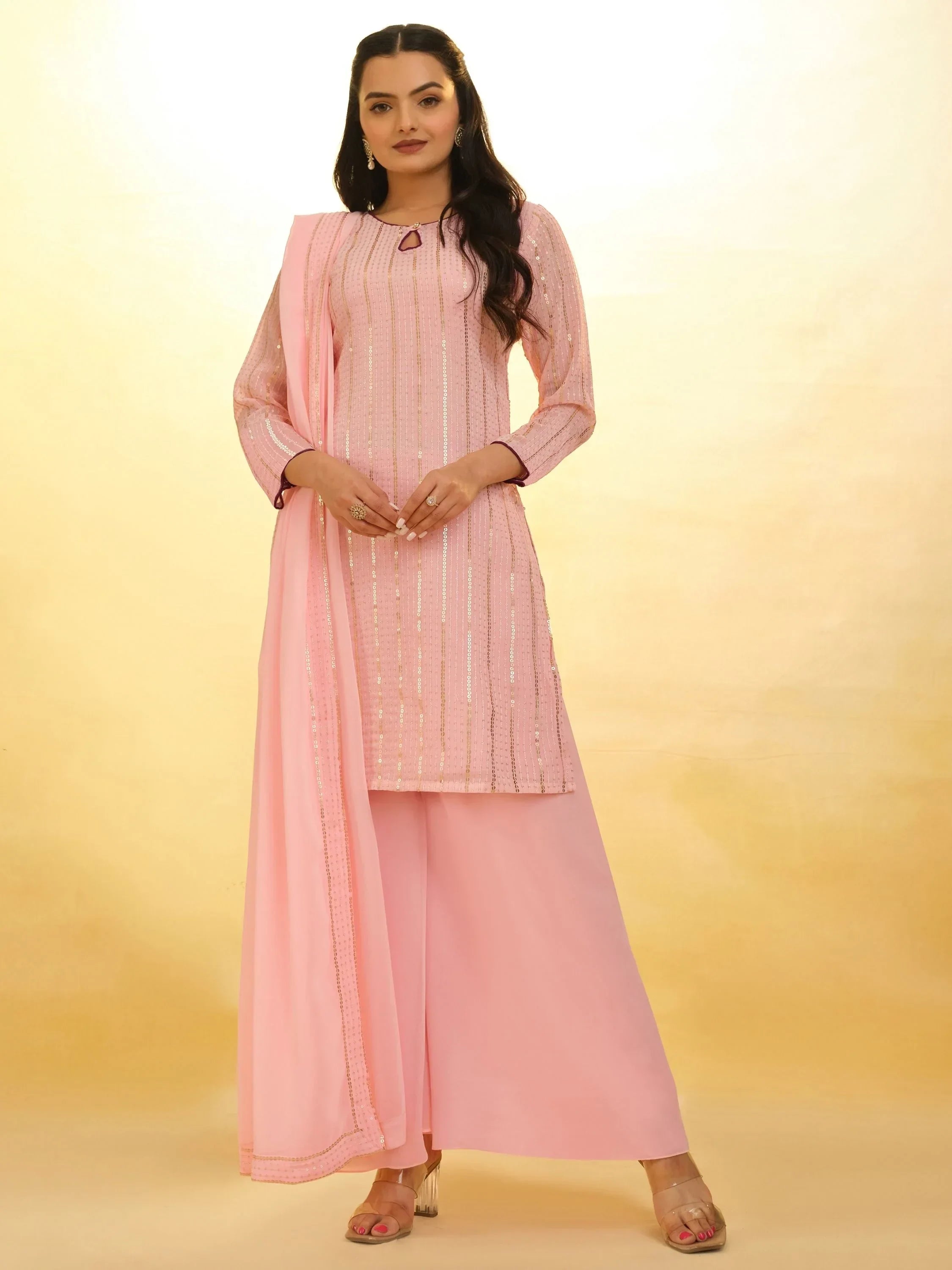 Woman in light pink embellished salwar kameez with matching dupatta, ethnic wear fashion