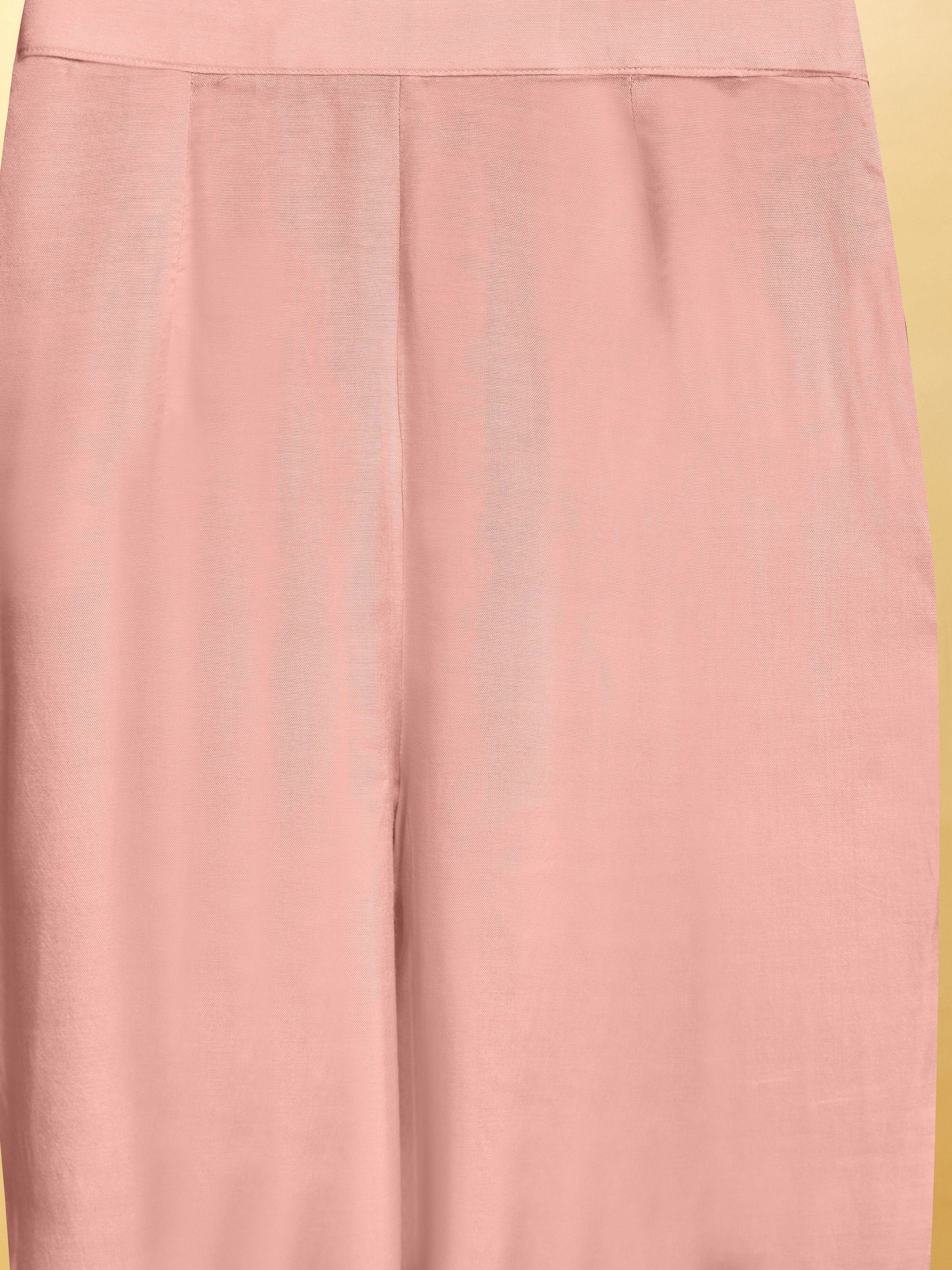 Close-up of pastel pink ethnic palazzo pants with soft fabric and straight cut