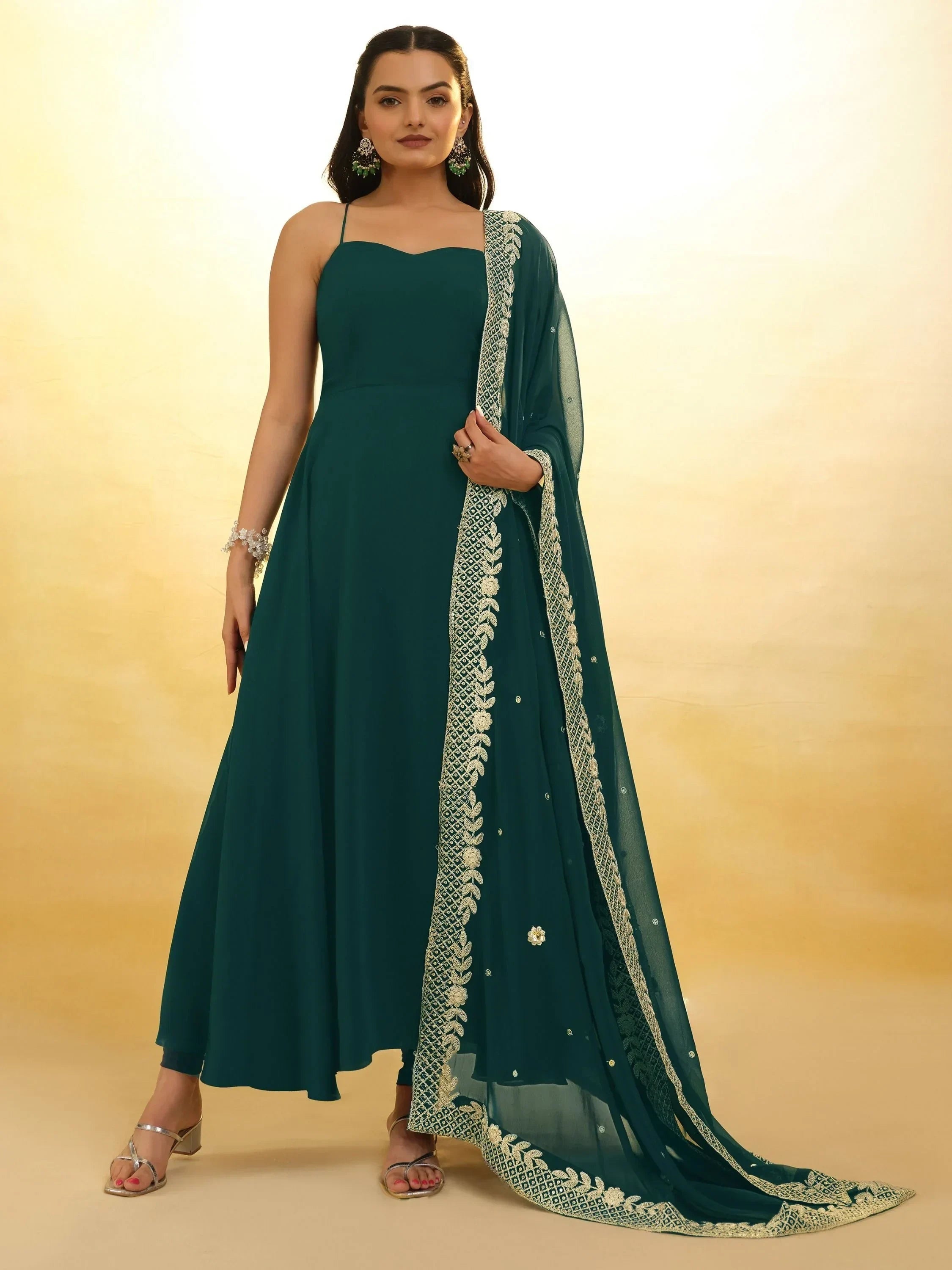 Woman wearing teal ethnic gown with thin straps and embroidered dupatta