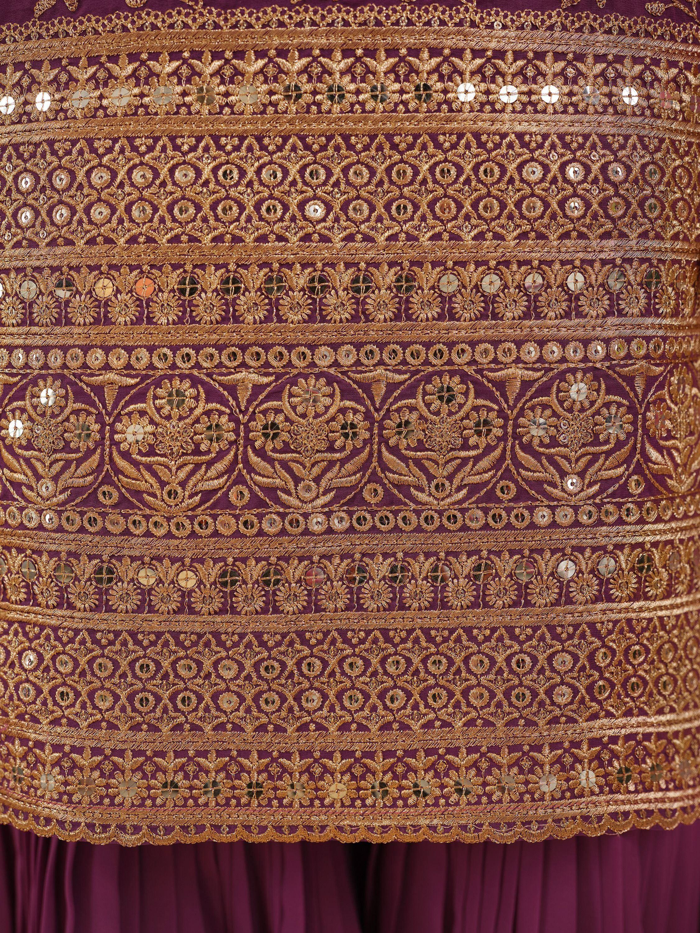 Purple ethnic gown with gold embroidery and mirror work details