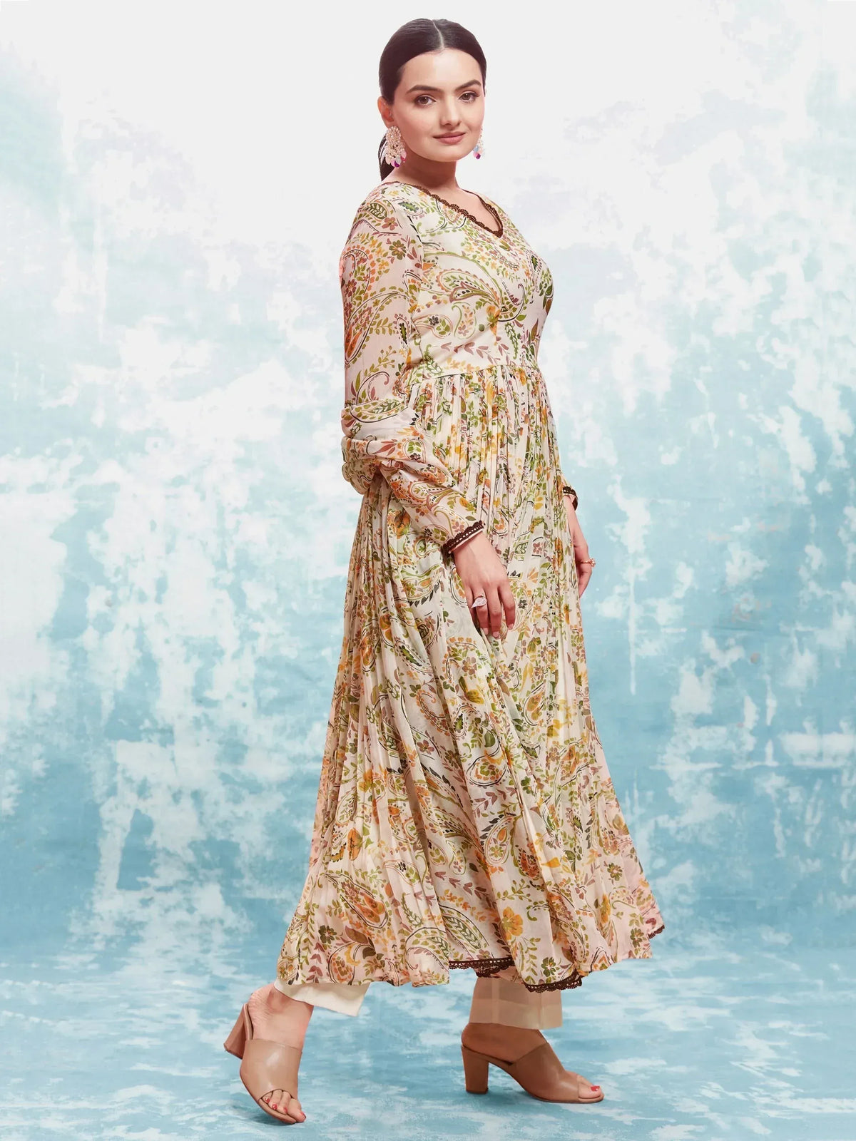 Floral printed ethnic gown with paisley design, long sleeves, and pleated skirt for women