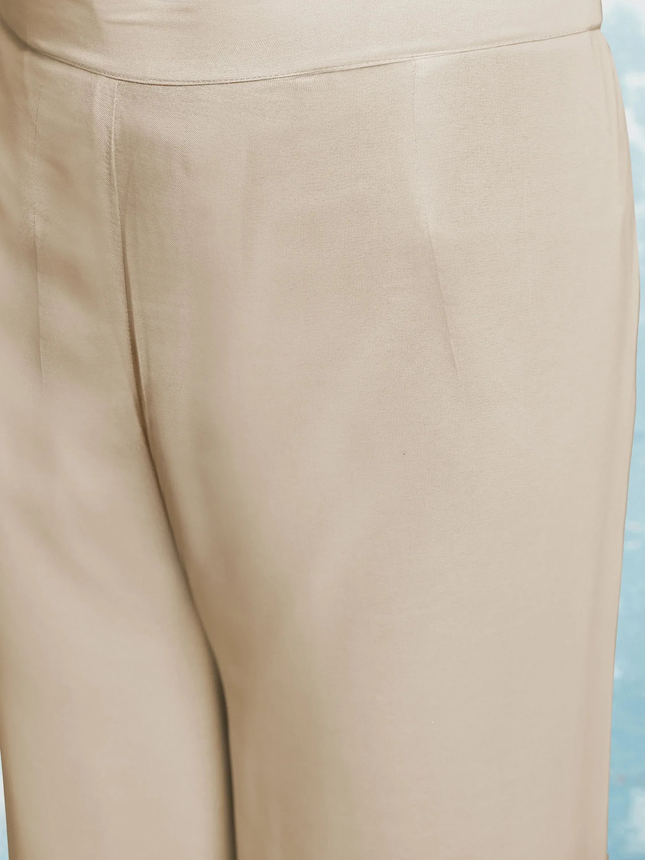 Close up of beige straight-fit women's ethnic pants with smooth texture