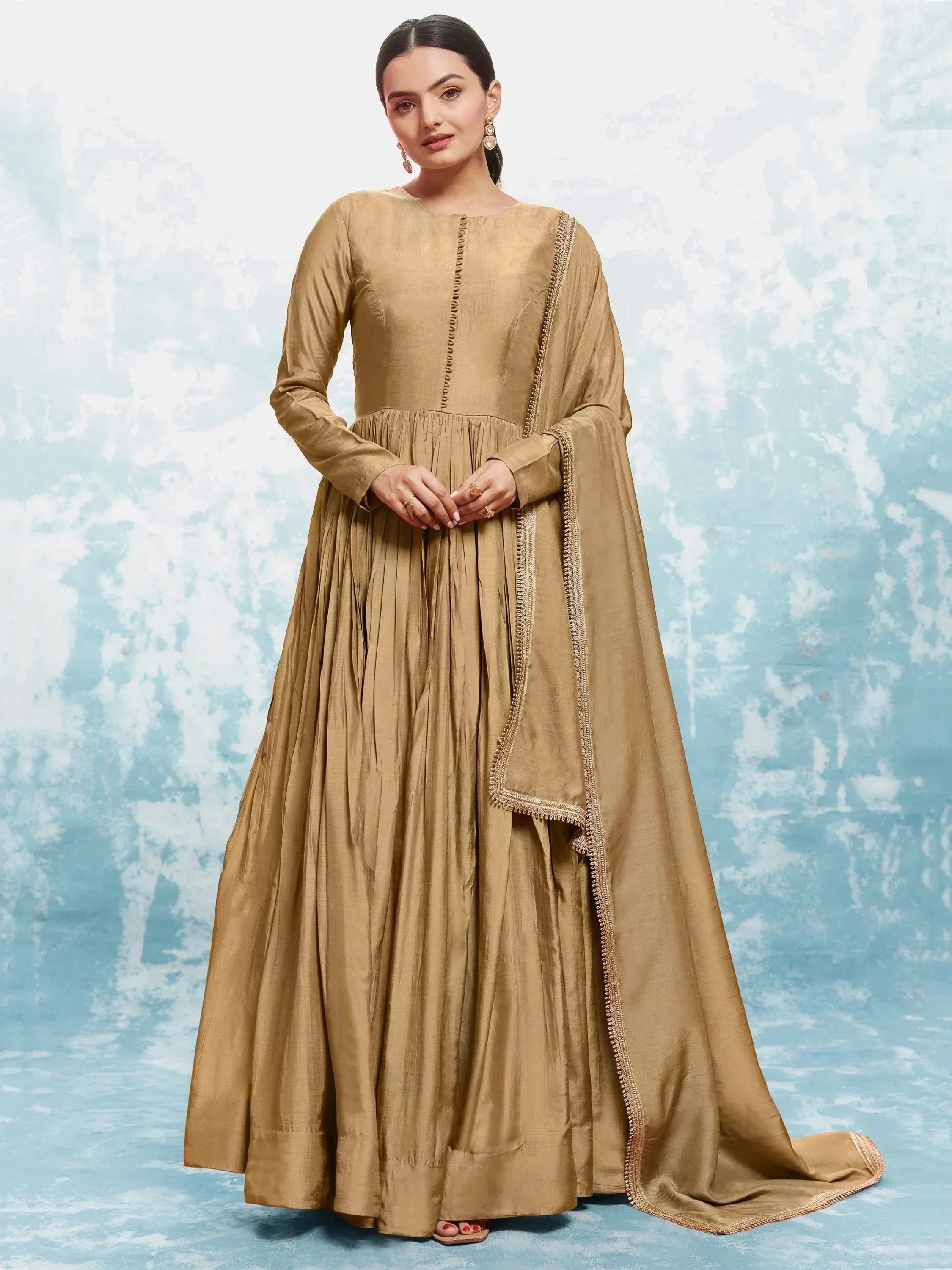Beige ethnic anarkali gown with pleated skirt and embroidered dupatta, perfect for Indian occasions.