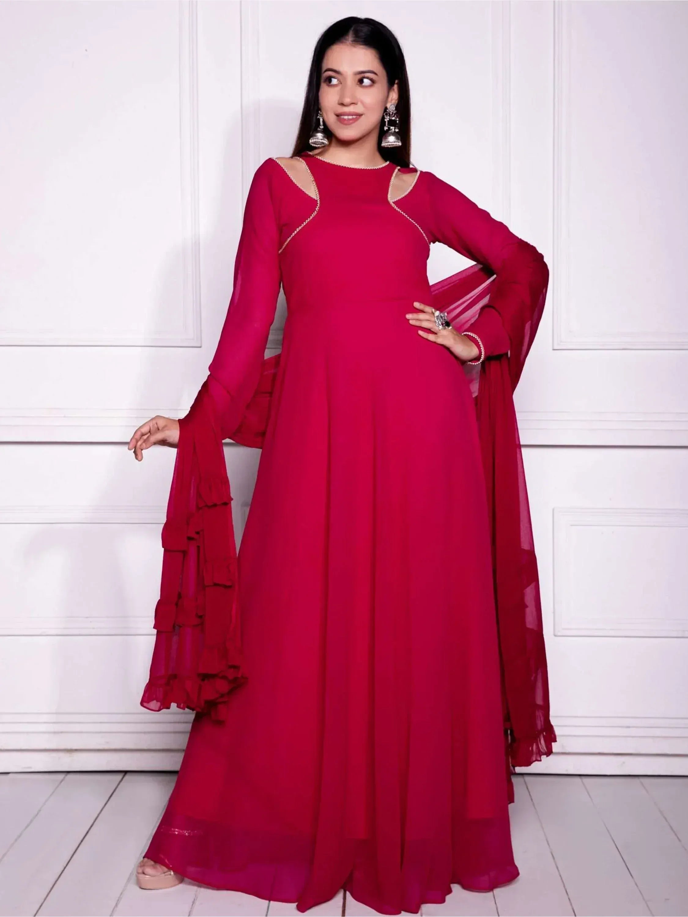 Red ethnic gown with cut-out shoulders and ruffled sleeves, perfect for Indian occasions