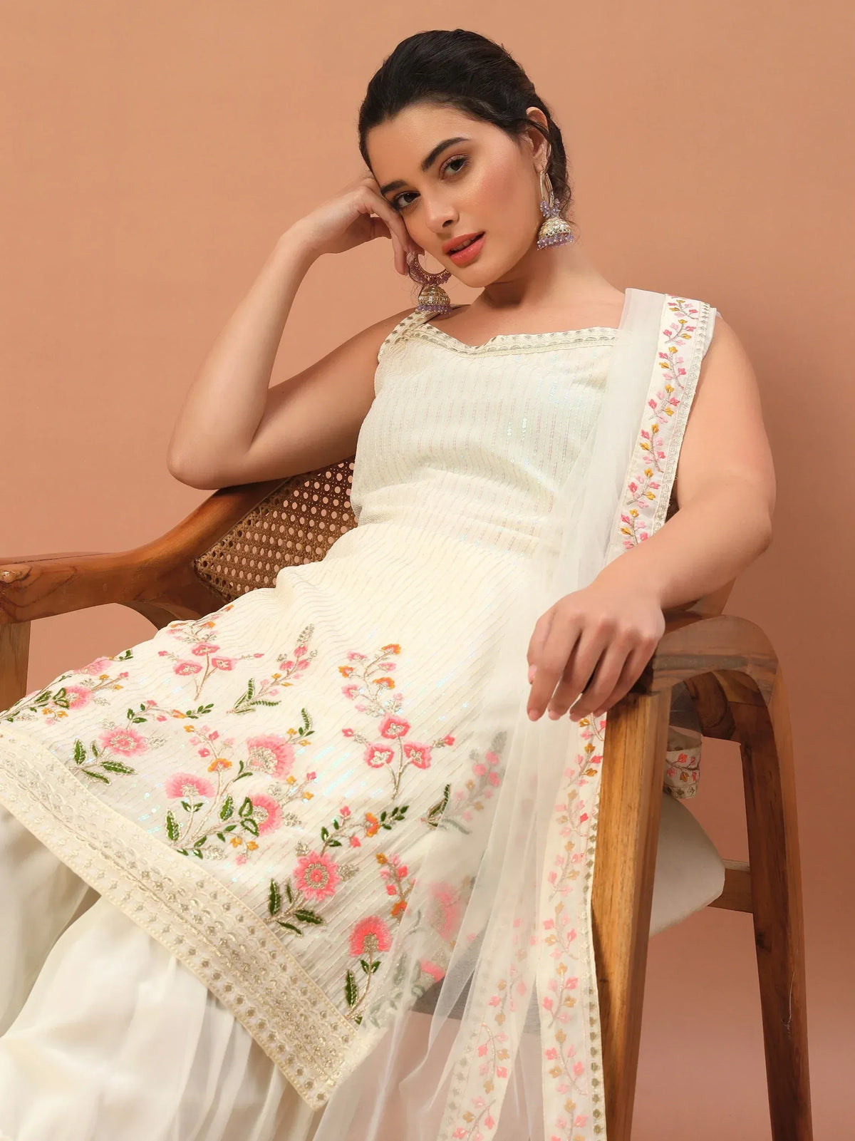 White floral embroidered ethnic gown with sheer dupatta, perfect for Indian occasions and celebrations.