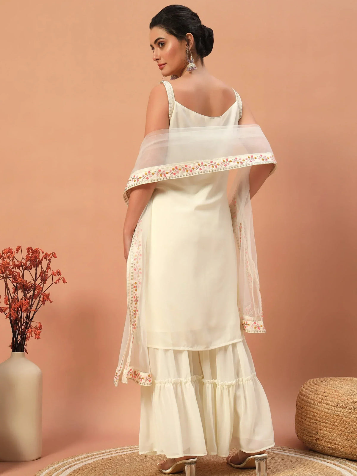 White ethnic gown with floral embroidery and tiered skirt, perfect for Indian occasions