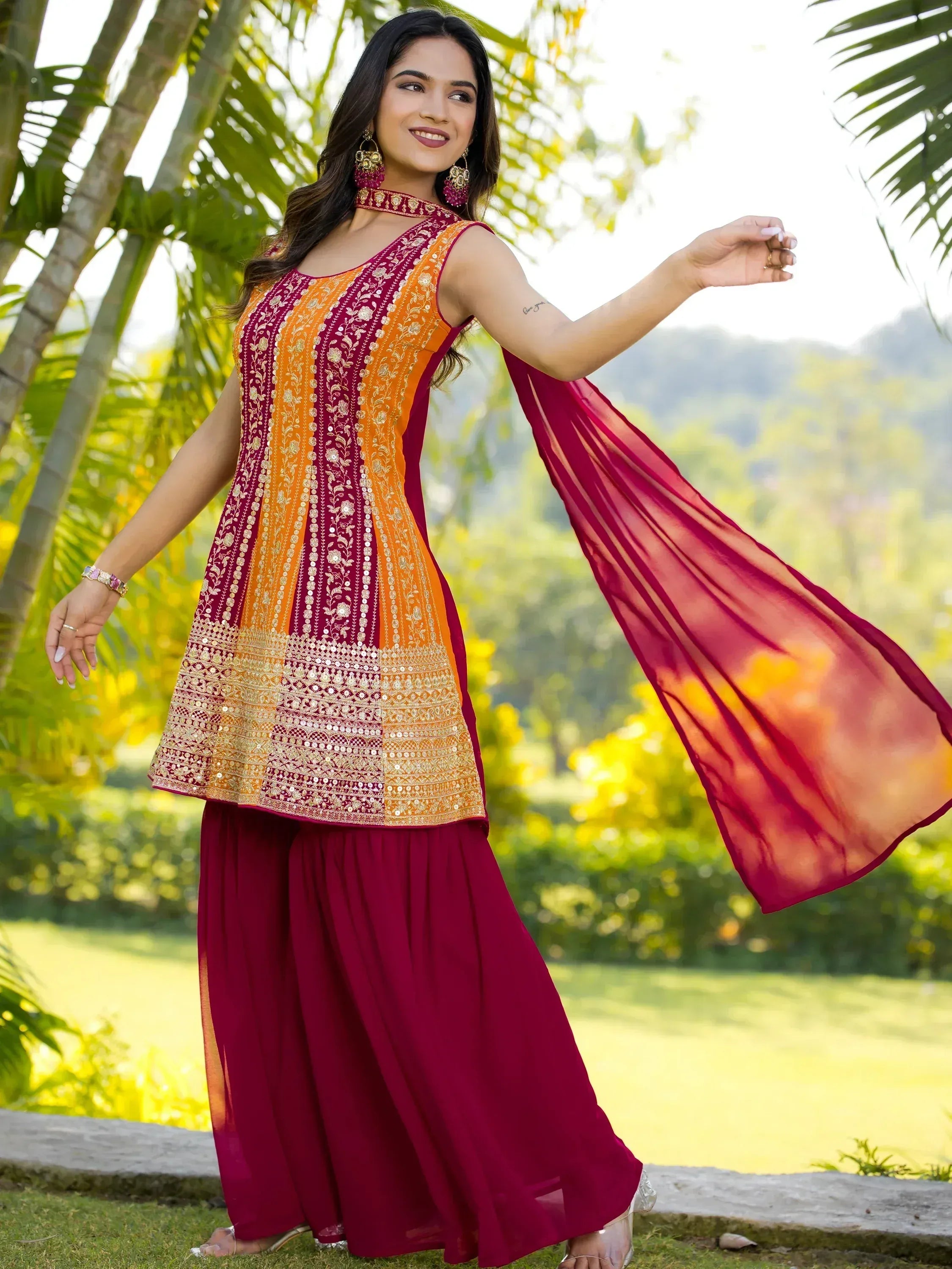Woman in maroon and orange embroidered ethnic kurta with palazzo pants and dupatta, perfect for Indian occasions