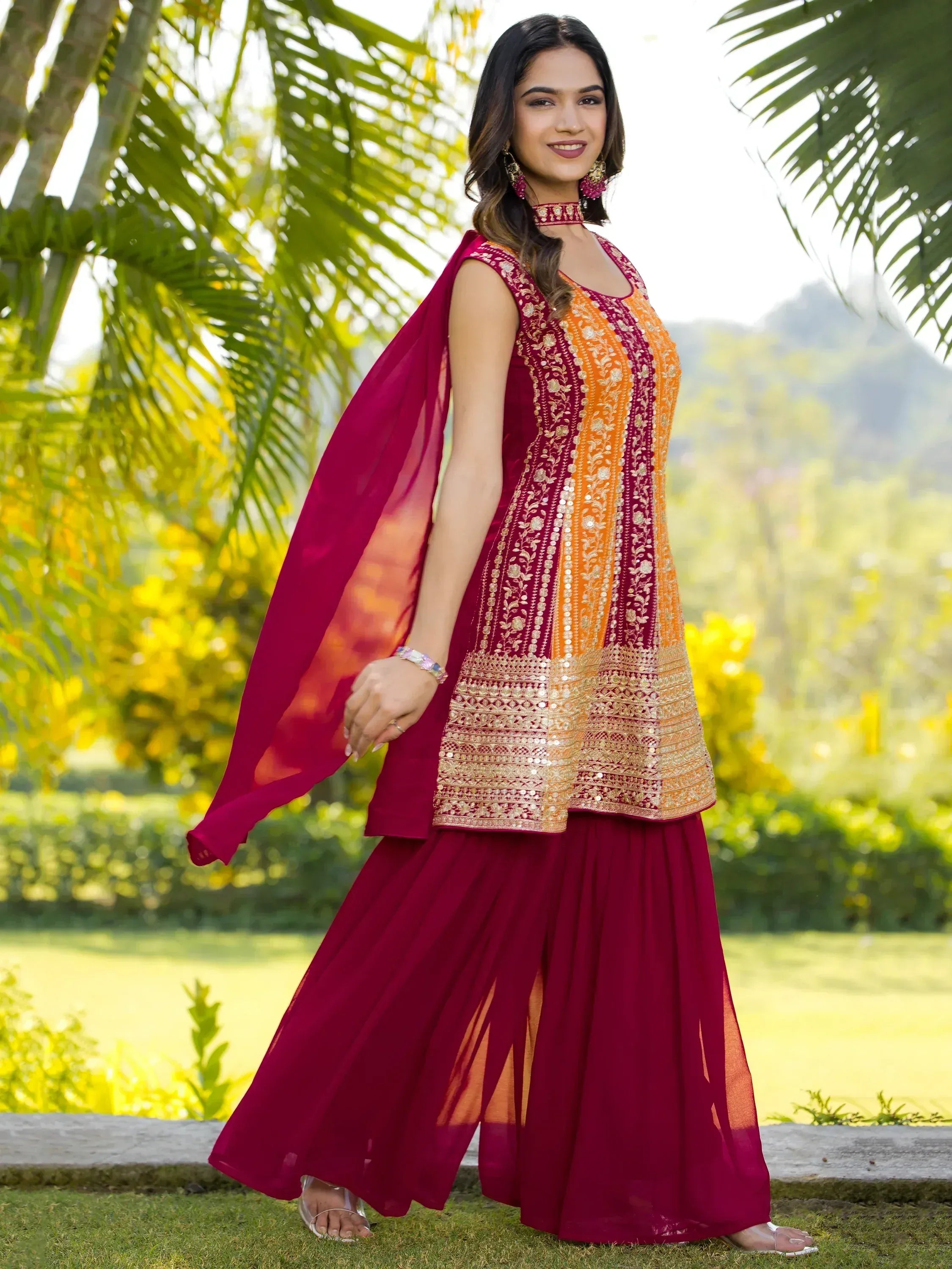 Woman in maroon and orange embroidered ethnic salwar kameez with dupatta, perfect for Indian festive occasions