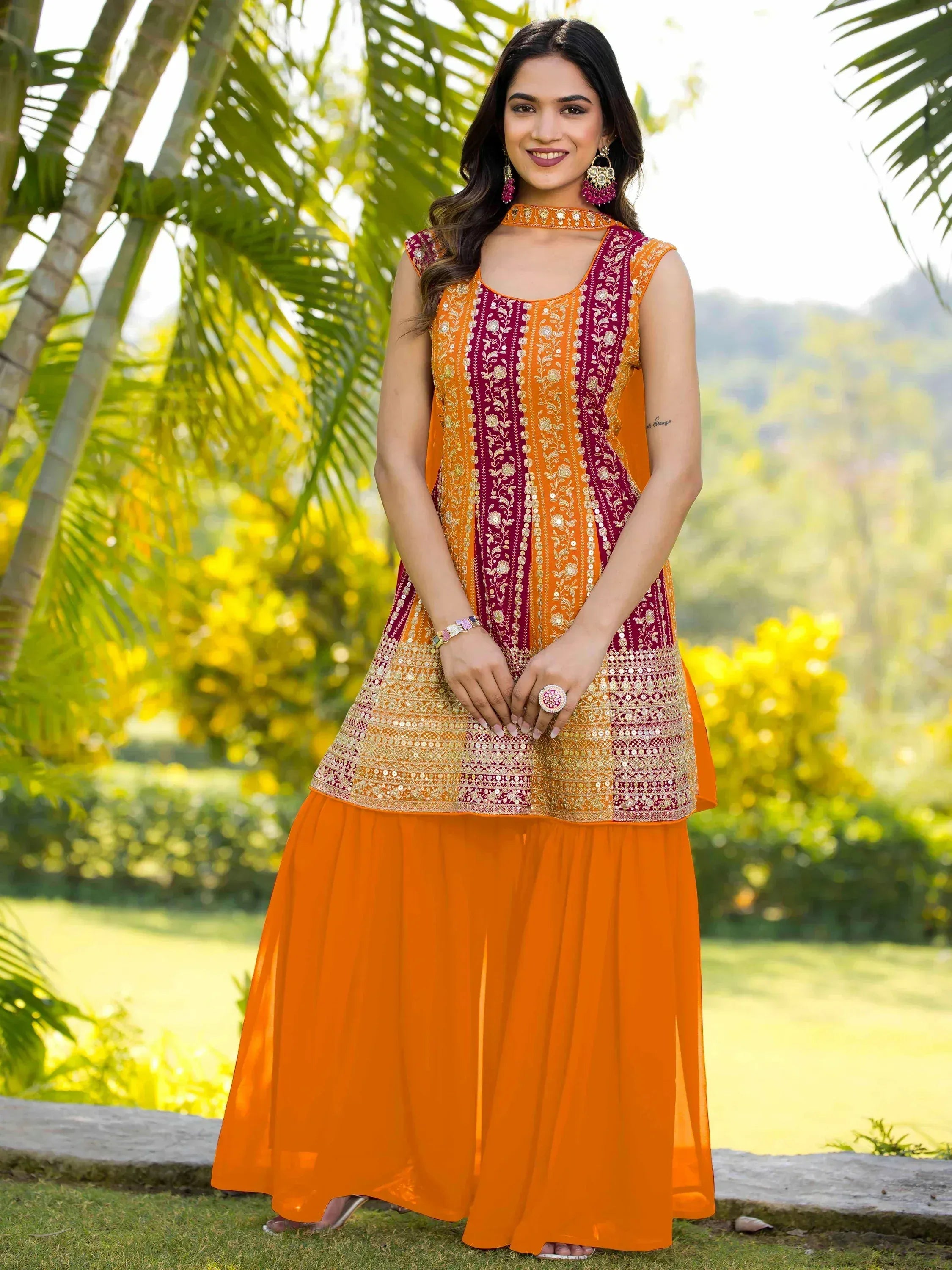 Orange and maroon embroidered ethnic gown with floral detailing, perfect for Indian festive occasions