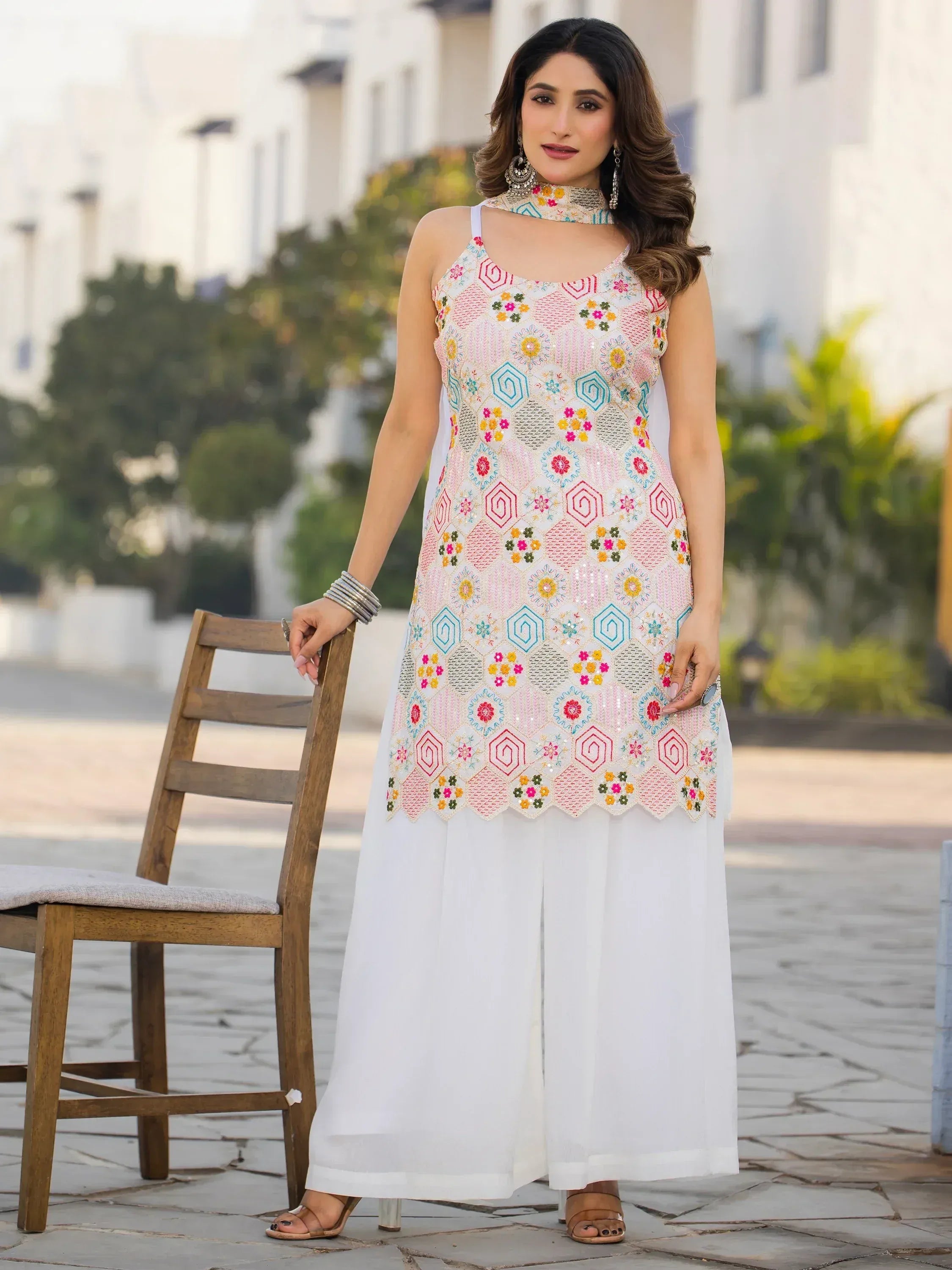 Colorful embroidered ethnic gown with floral patterns and white palazzo pants