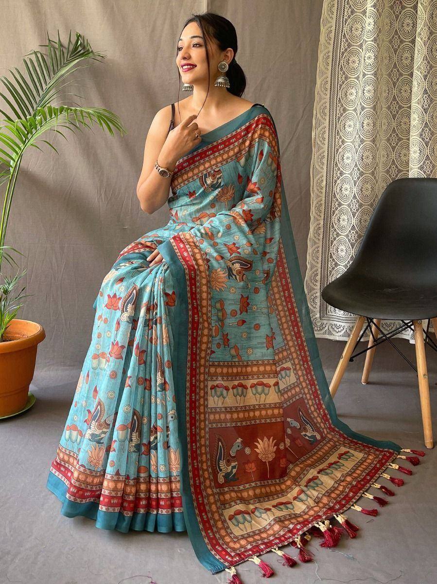Woman in blue printed saree with red border and tassels, ethnic Indian wear