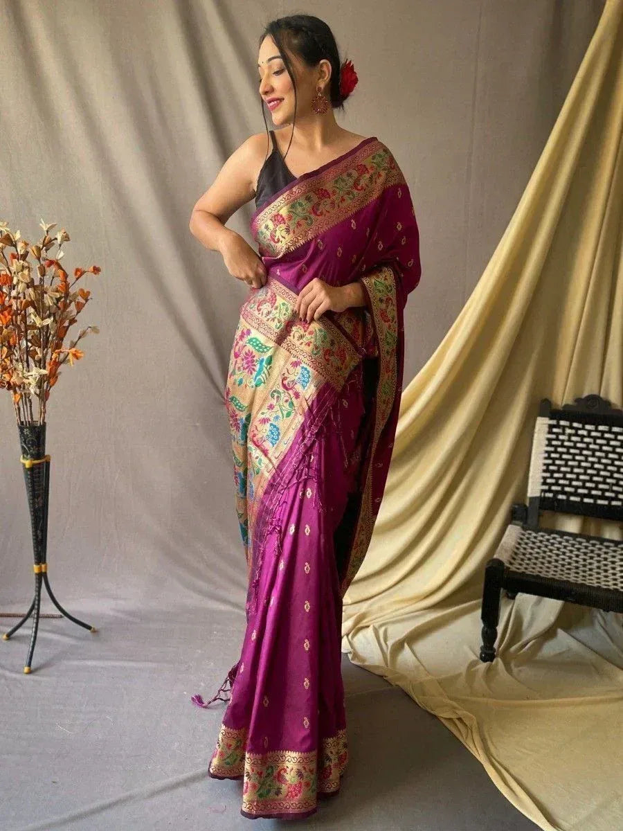 Woman in vibrant purple ethnic saree with floral embroidery, styled for Indian occasions