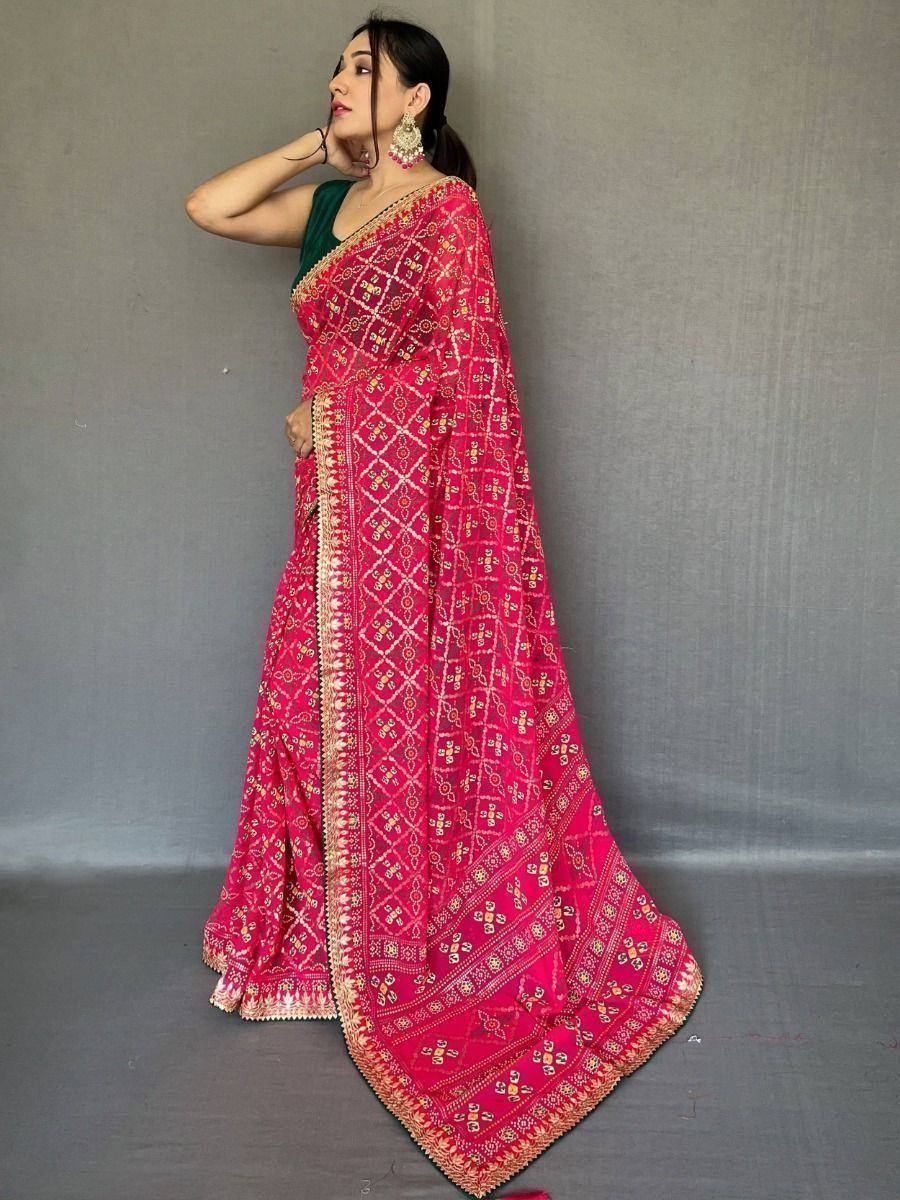 Pink embroidered saree with gold border, paired with green blouse, perfect for ethnic occasions