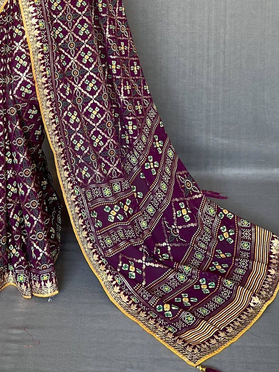 Purple ethnic saree with intricate geometric embroidery and golden border, ideal for Indian festive wear