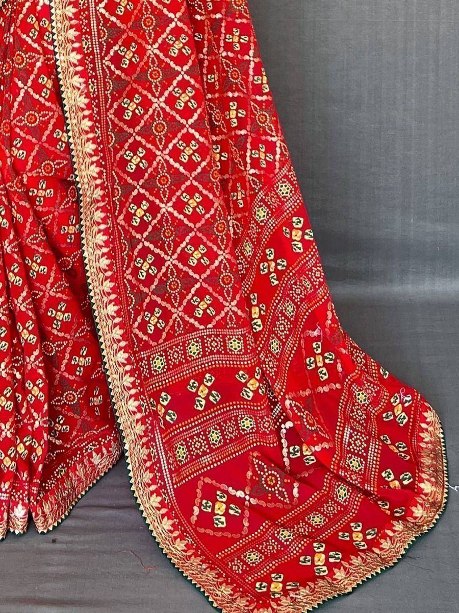 Red ethnic lehenga with intricate gold and mirror work, perfect for Indian weddings and festive occasions