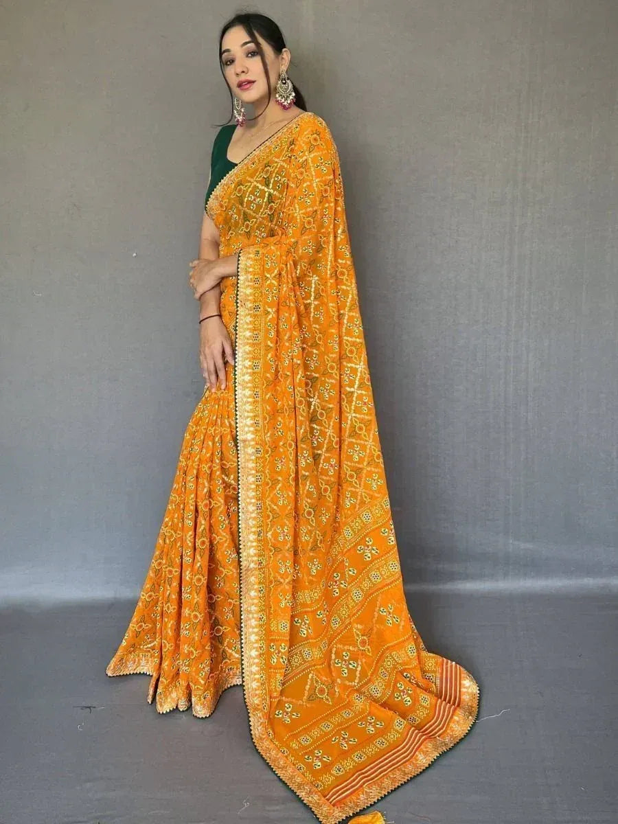 Vibrant orange embroidered saree with green blouse, perfect for Indian ethnic occasions and festive wear.