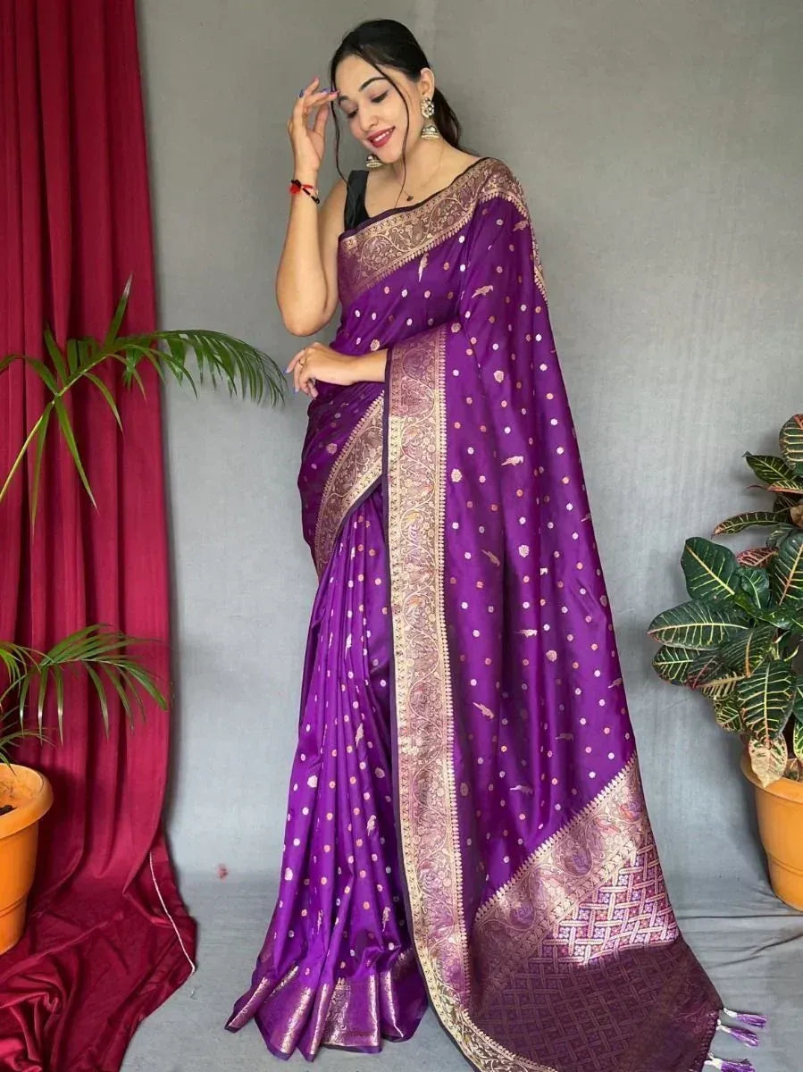 Purple designer saree with gold zari border and polka dot pattern, styled with black blouse for ethnic wear