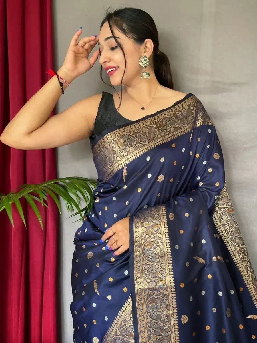 Navy blue designer saree with gold floral and bird motifs, paired with black blouse, perfect for ethnic occasions.