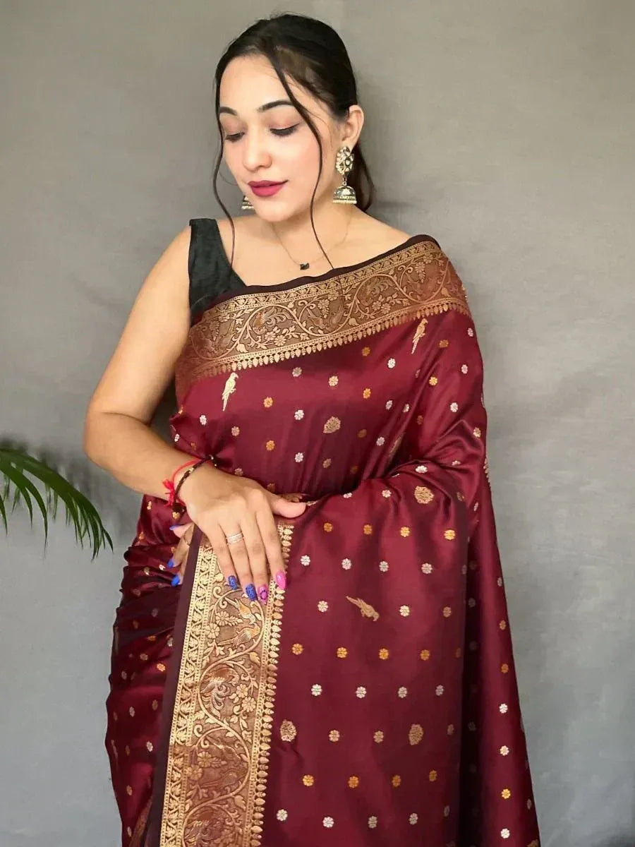Maroon silk saree with gold embroidery and floral motifs, paired with black blouse for ethnic wear